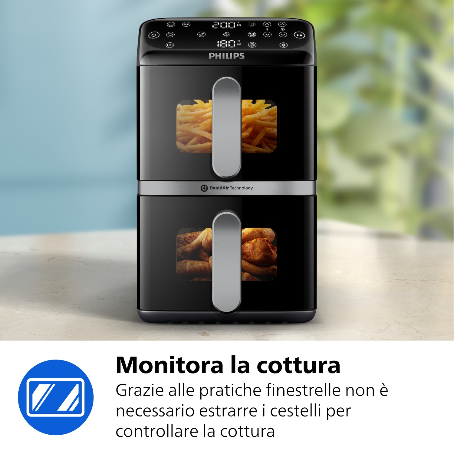Una friggitrice ad aria Philips nera a due cassetti. Patatine fritte sopra, pollo sotto.