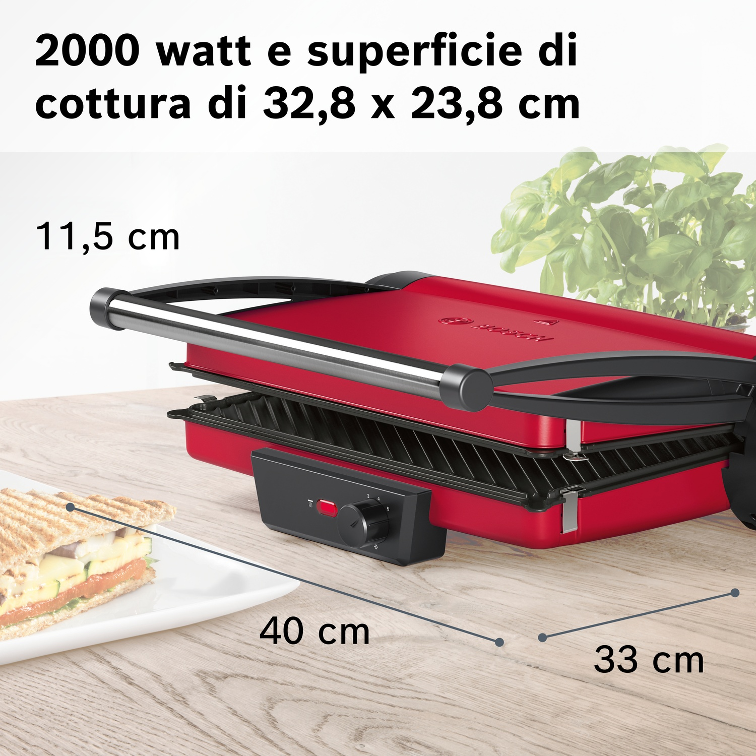 Grill rosso con sandwich su piatto accanto. Dimensioni indicate.