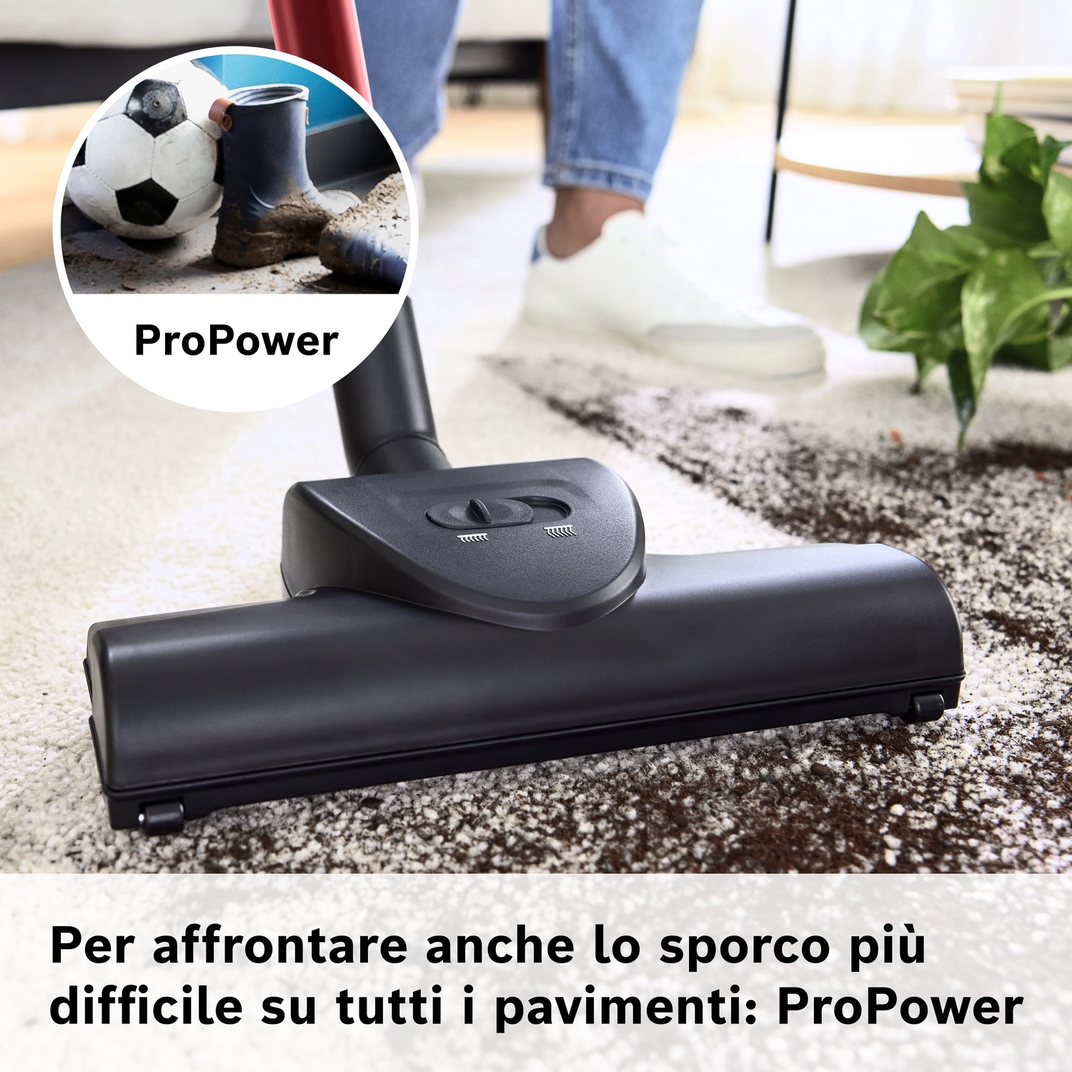 Testa aspirapolvere pulisce tappeto con terra e pallone.