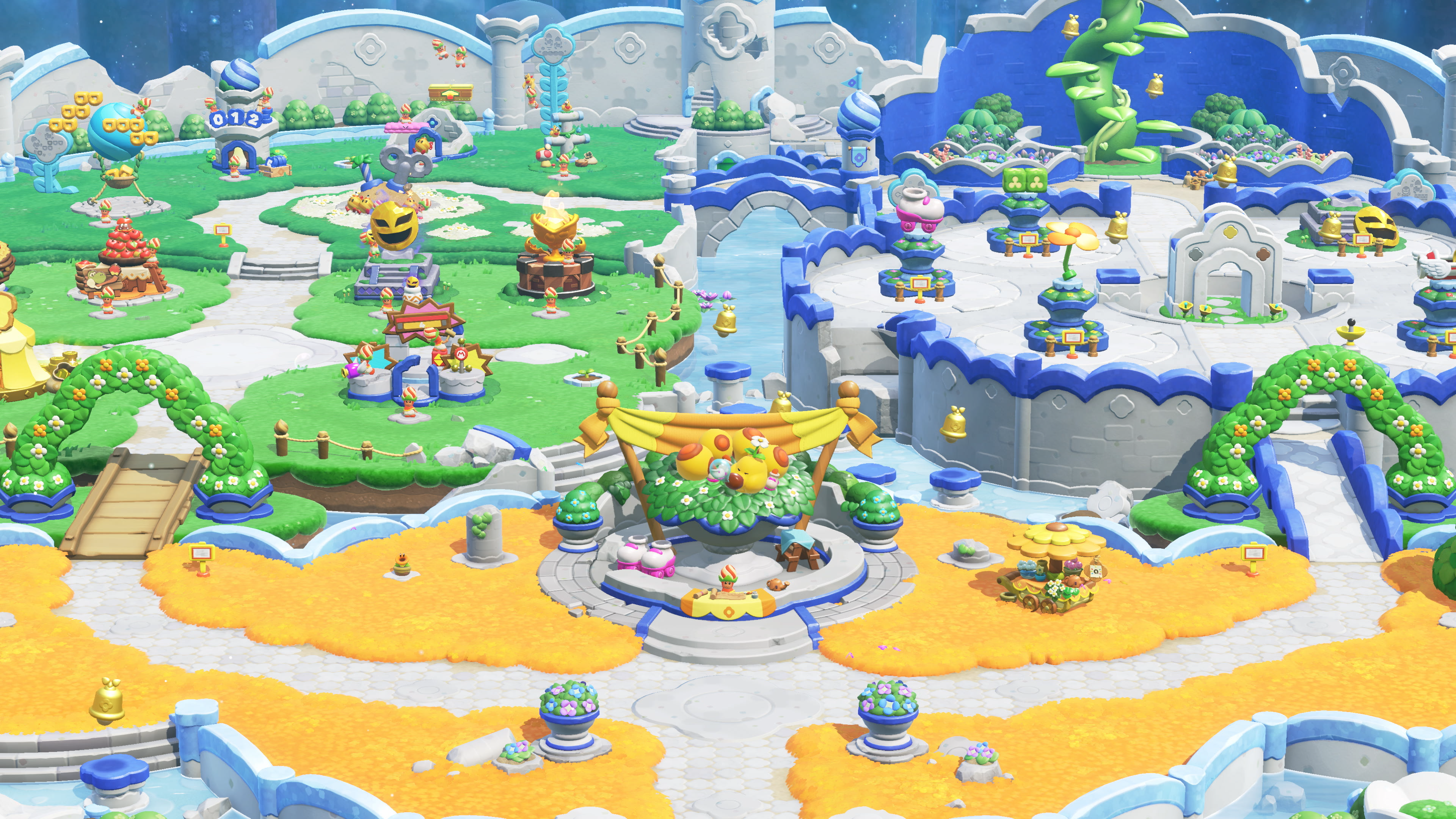 Un mondo fantasy con colori vivaci, colline verdi, acqua blu e strutture bianche.