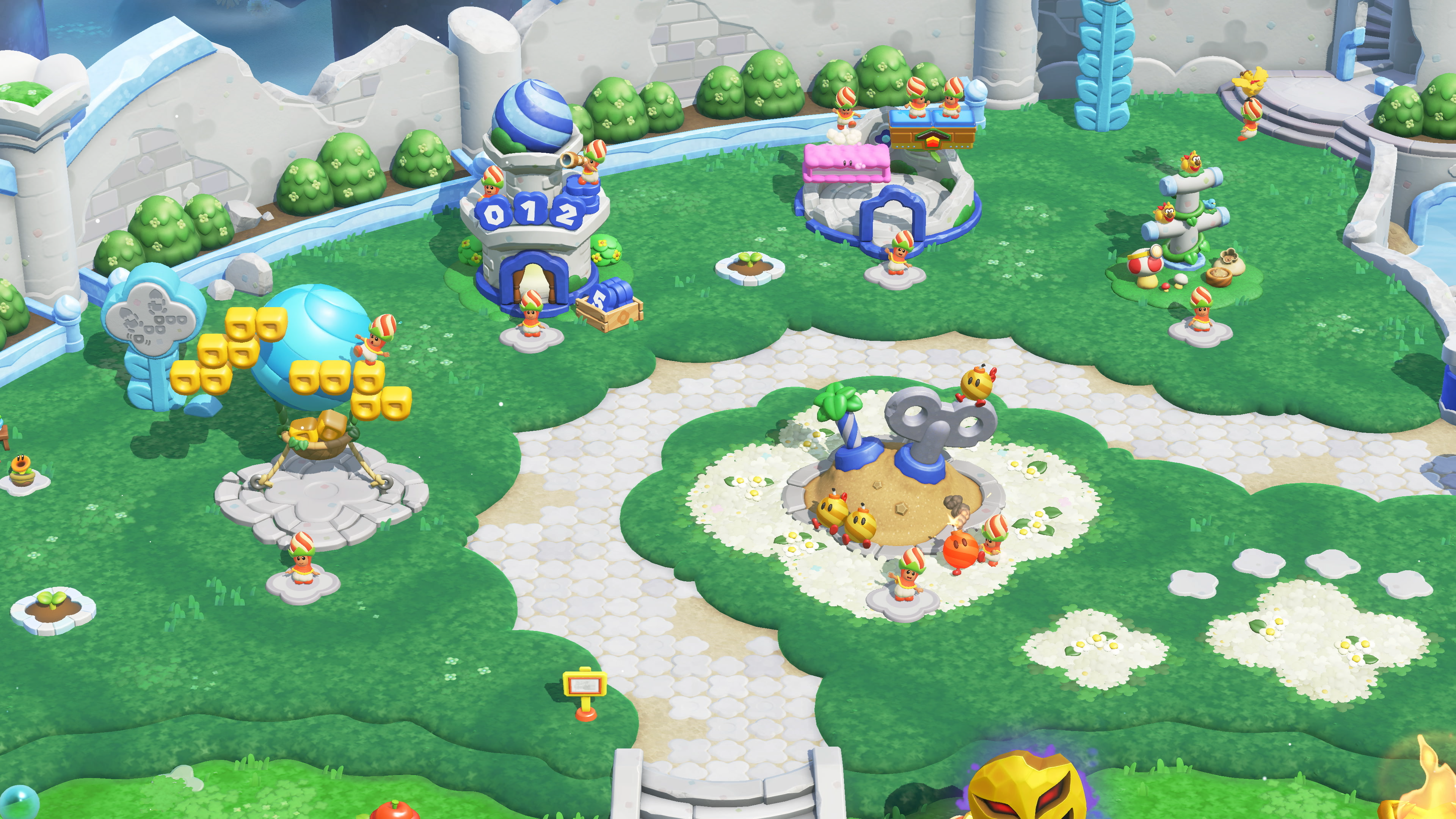Mondo di gioco colorato con figure, palle blu e cespugli verdi.