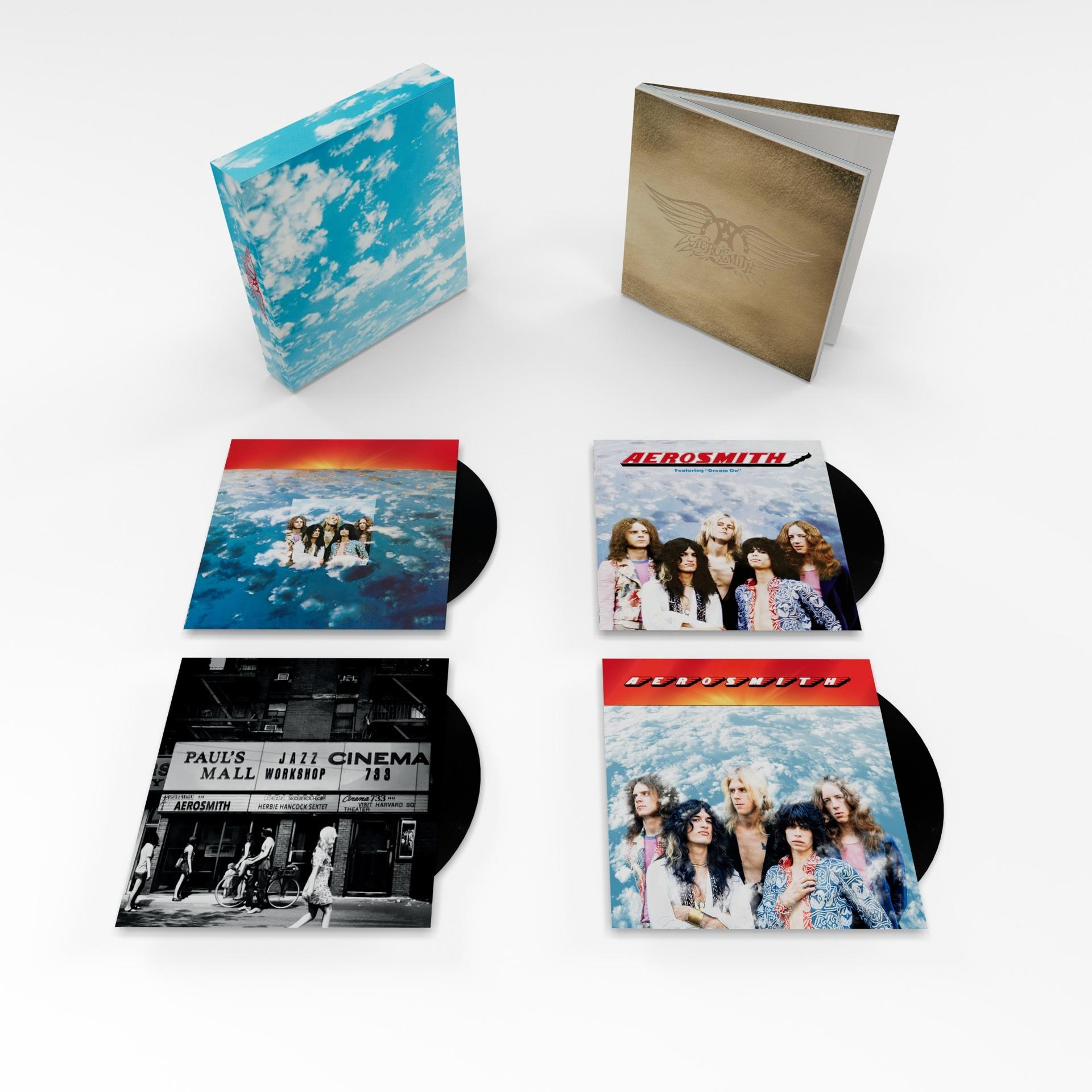 Vier Aerosmith-Schallplatten und zwei Bücher auf weißem Hintergrund.
