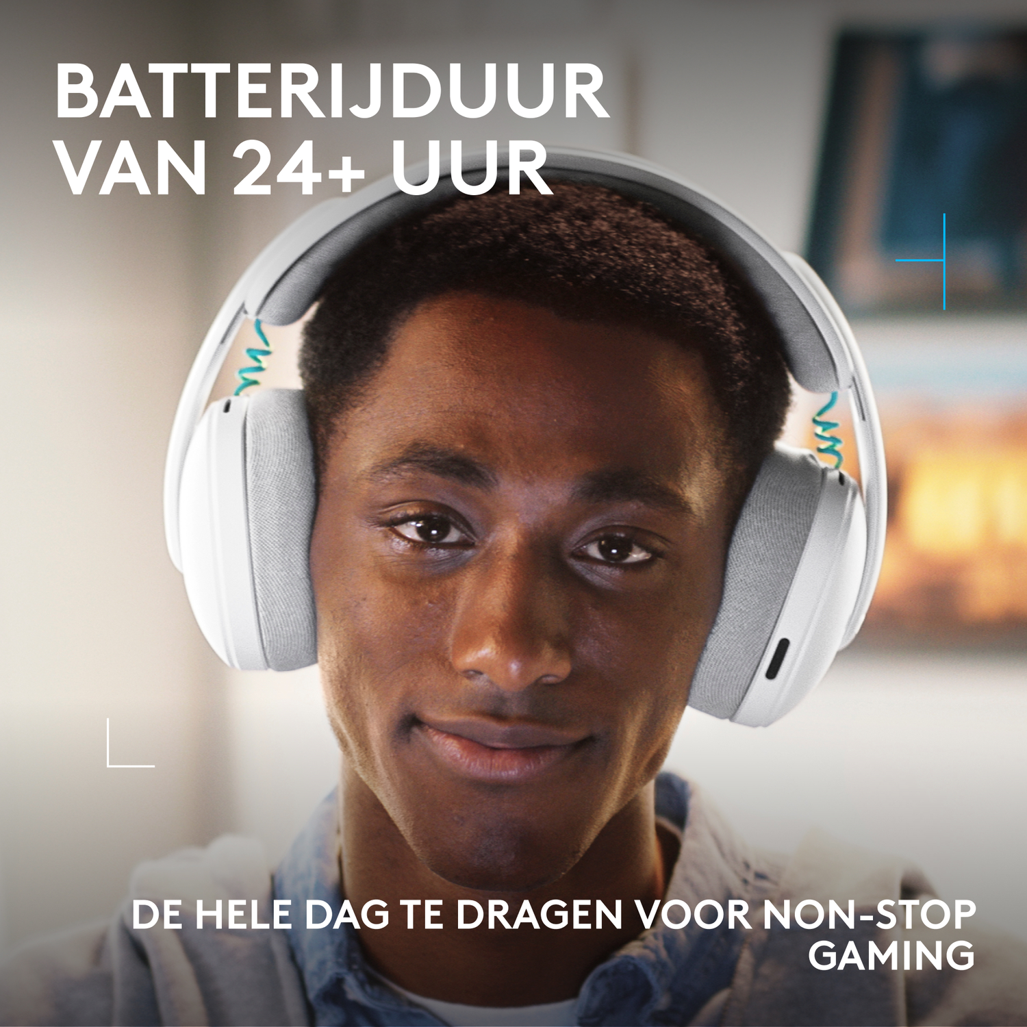 A man wears white headphones with a blue cord. Text about battery life.