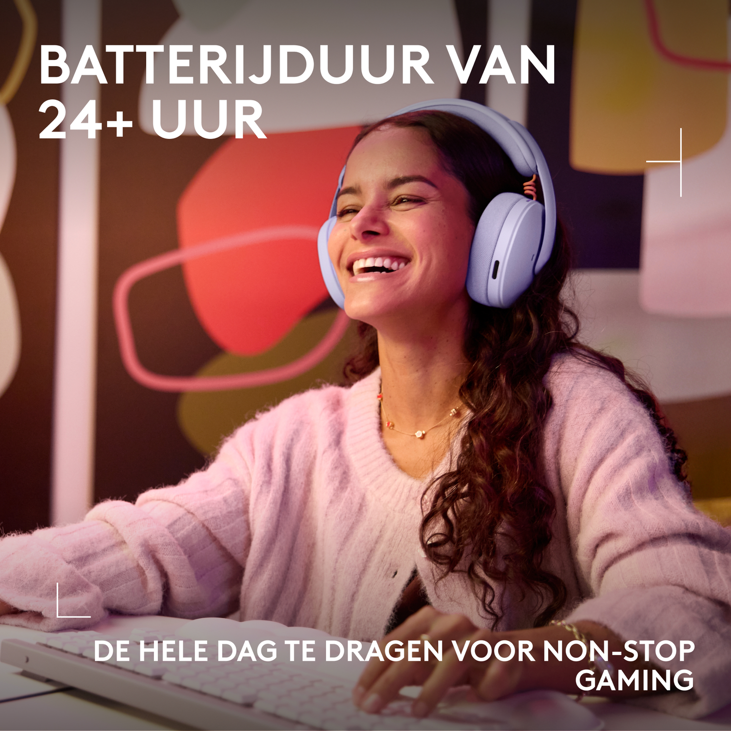 A smiling woman wearing headphones sits at a computer. Text about battery life.