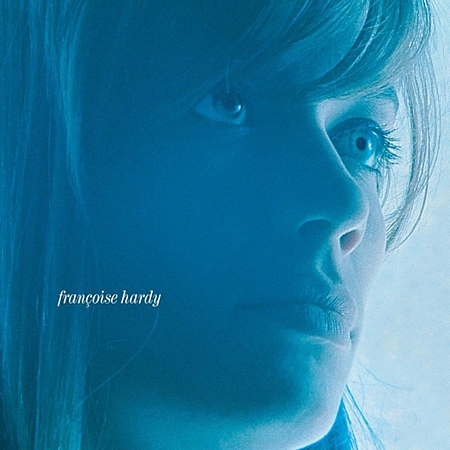 Close-up portret van vrouw met blauwe ogen en blond haar, tekst "françoise hardy".