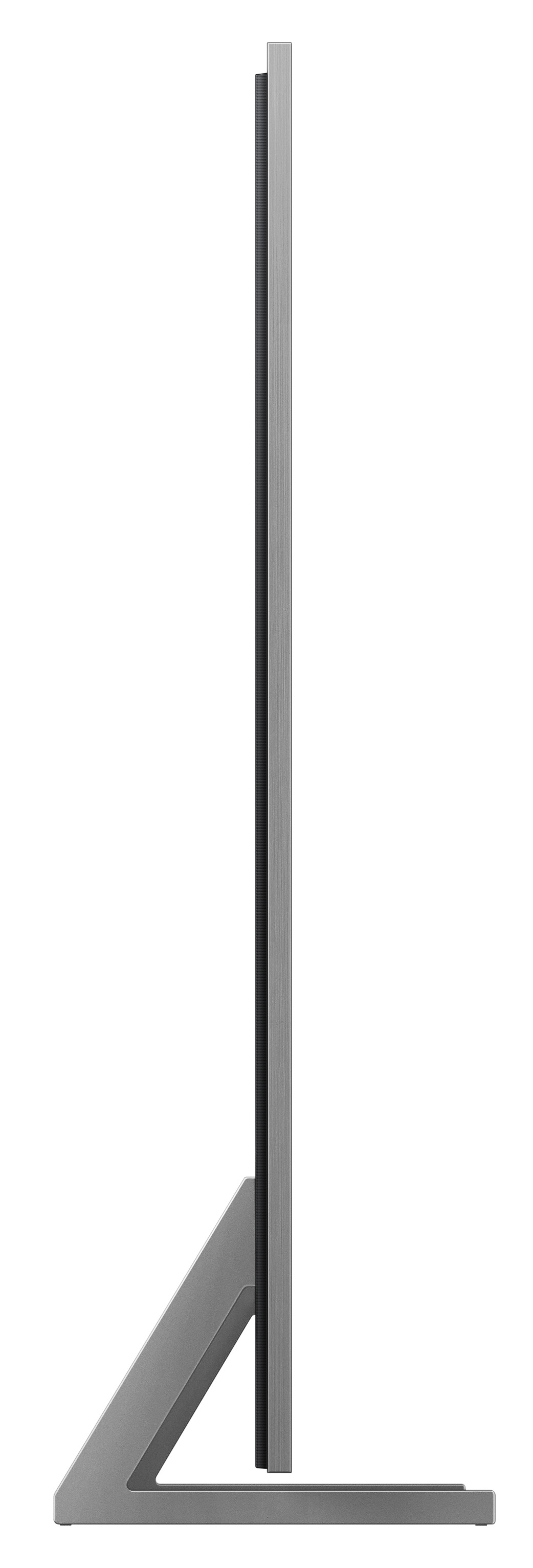 Szary, smukły telewizor ze srebrnym stojakiem, widziany z boku.