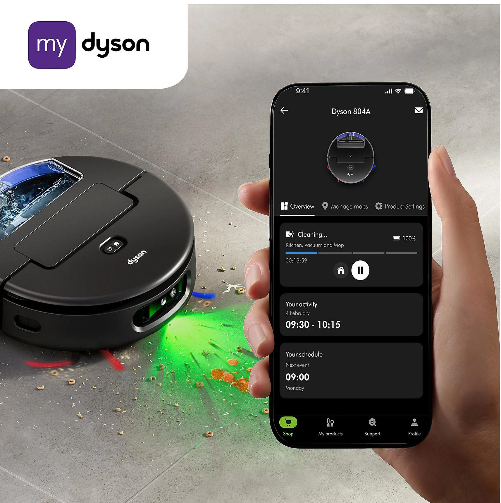 Czarny robot sprzątający Dyson czyści podłogę. Aplikacja na smartfonie pokazuje.