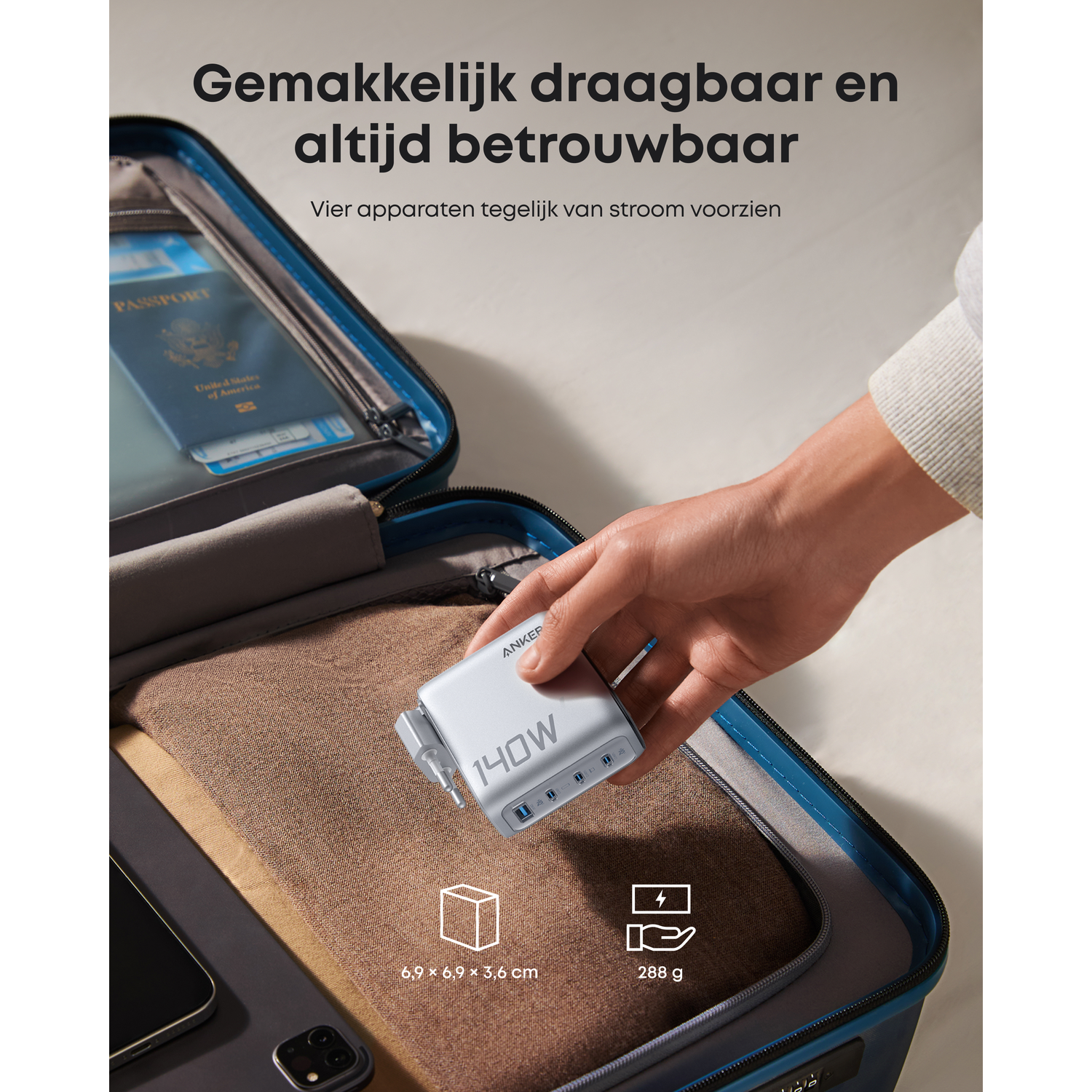 A hand holds a silver 140W charger inside a suitcase with a passport.