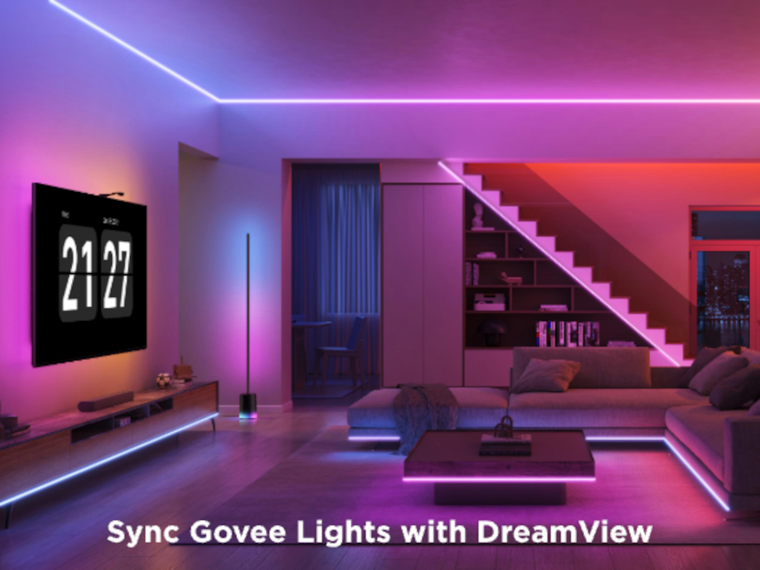 Ein Wohnzimmer mit modernen Möbeln und farbigen LED-Lichtern.