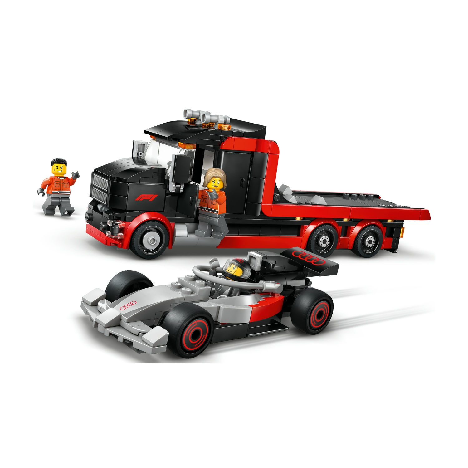 Un camion Lego nero e rosso trasporta un'auto da corsa Lego grigia e rossa. Due figure Lego si trovano nelle vicinanze.