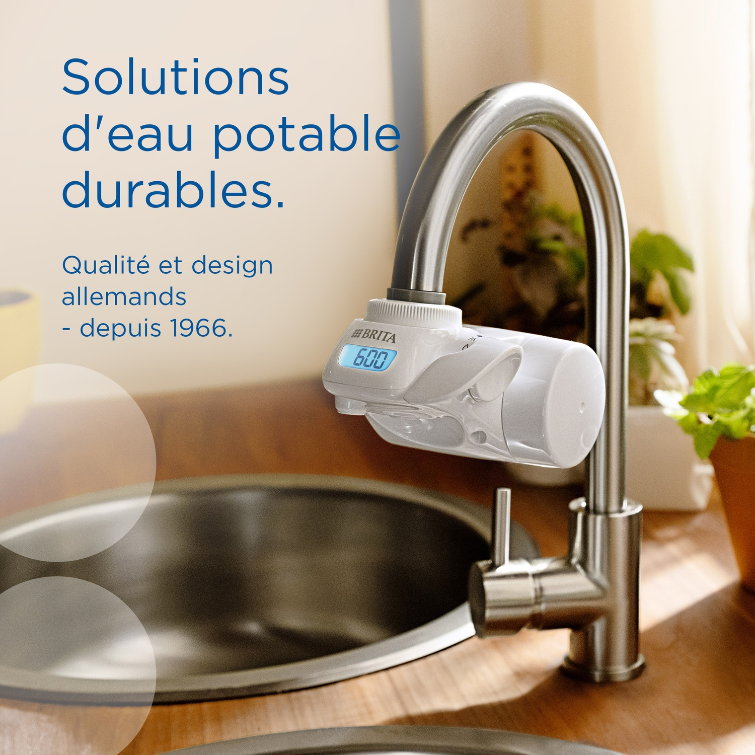 Brita water filter attached to a faucet above a sink. Digital display.
