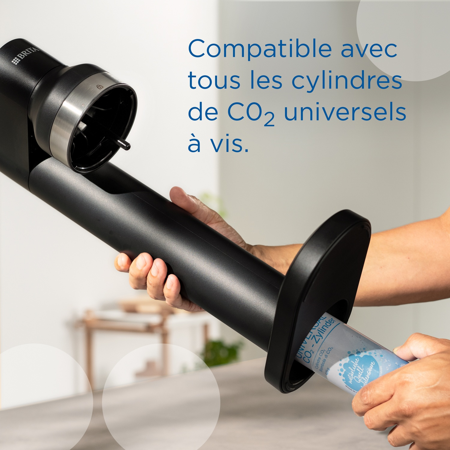 Person inserts CO2 cylinder into black device. Device is from Brita.