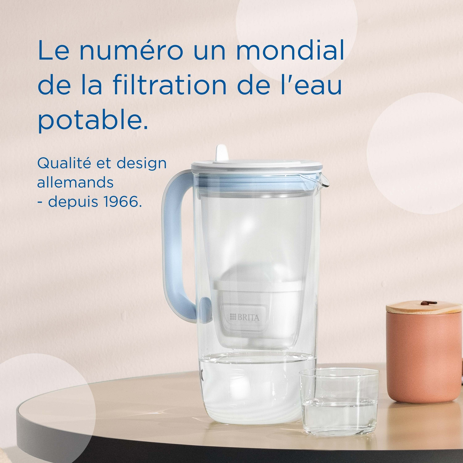 Brita water filter pitcher with glass and container on table.