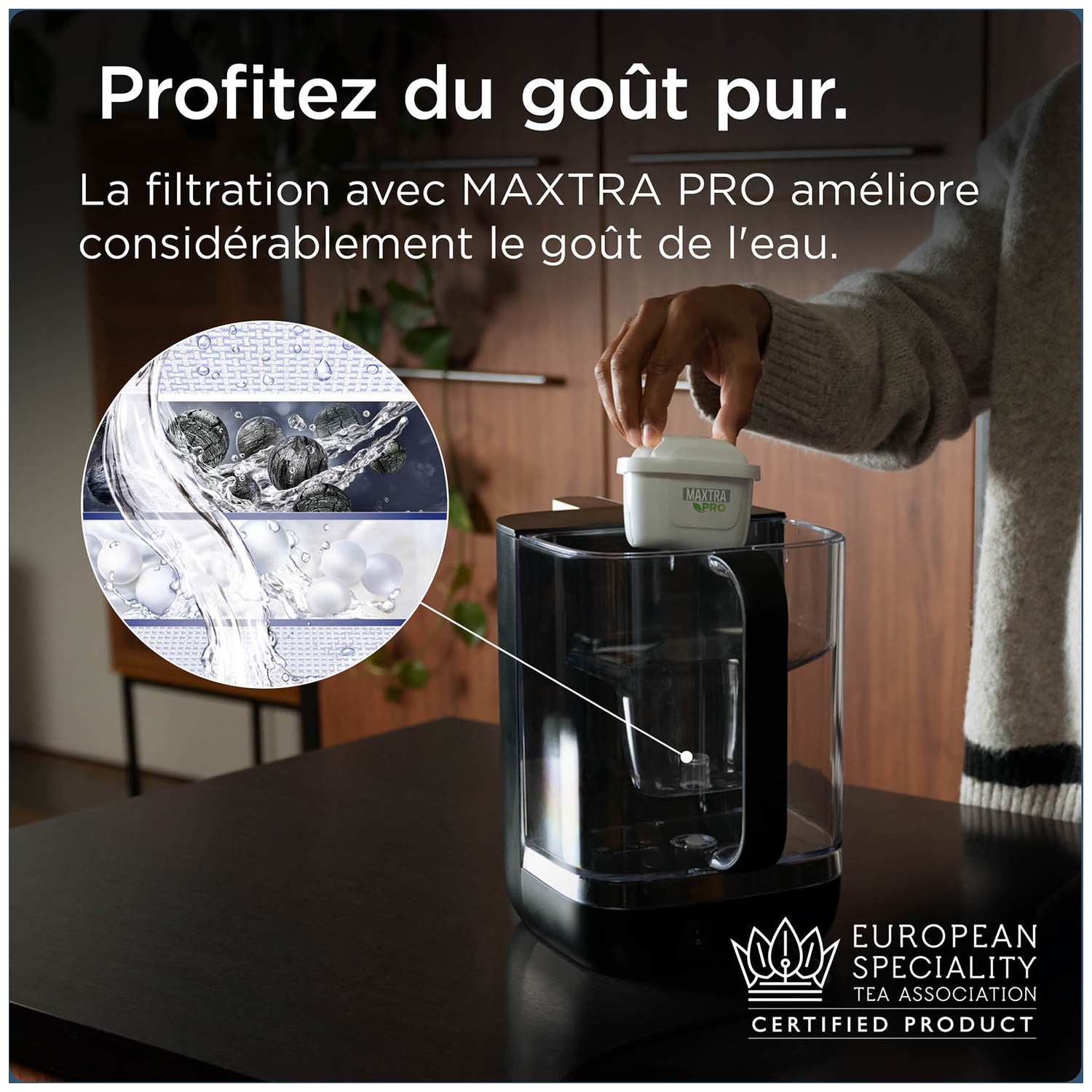 Person inserts MAXTRA PRO filter into water filter. Close-up view.