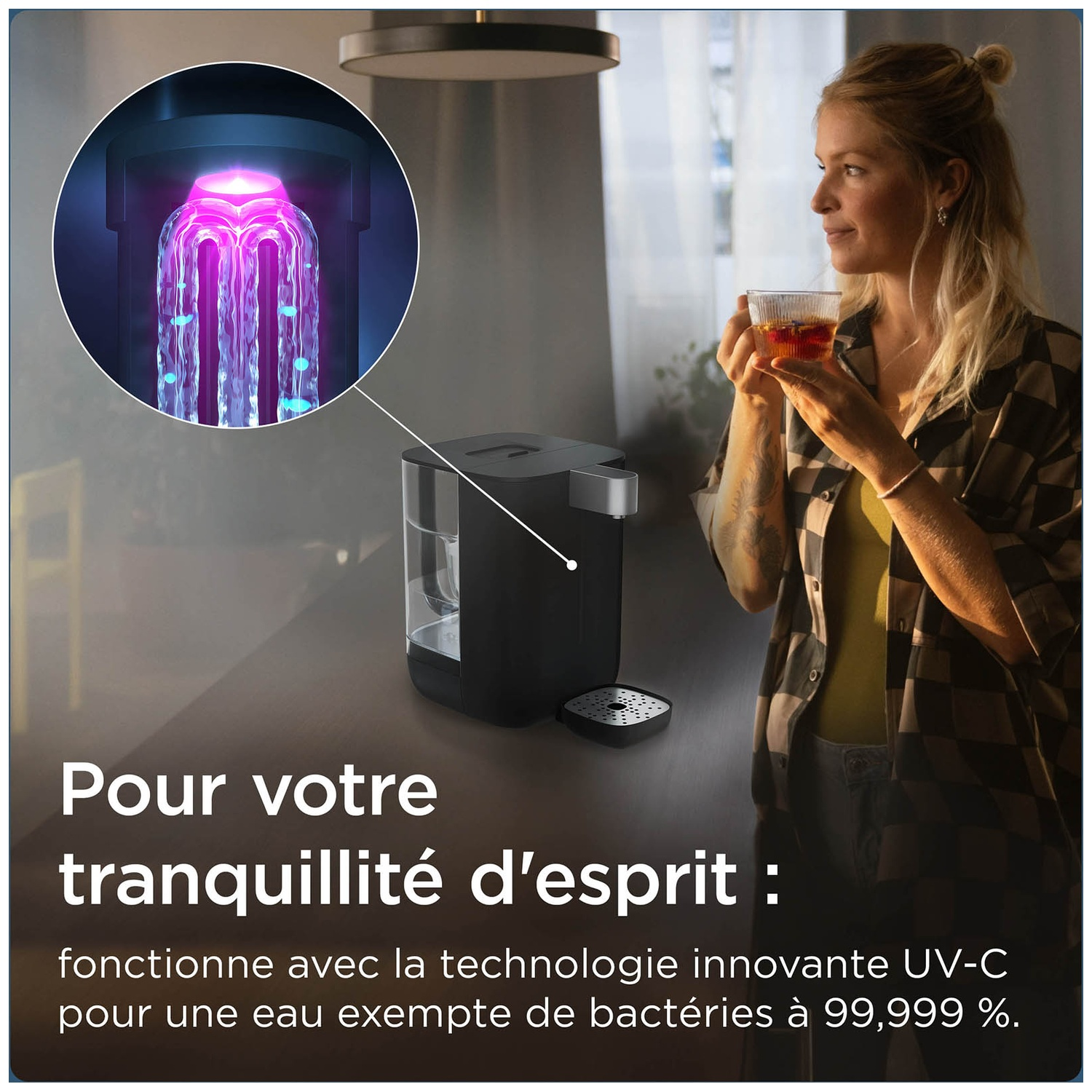Woman drinks tea next to a water purifier with UV-C technology.