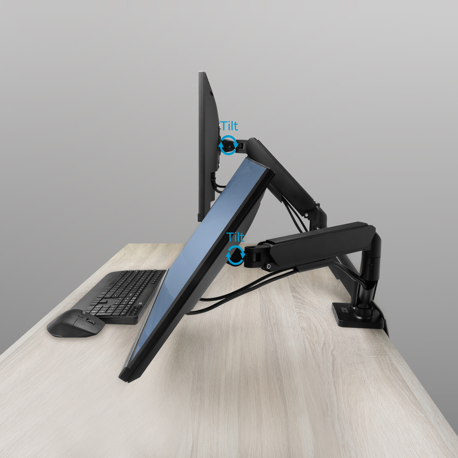 Two monitors on a black arm with keyboard and mouse on a desk.