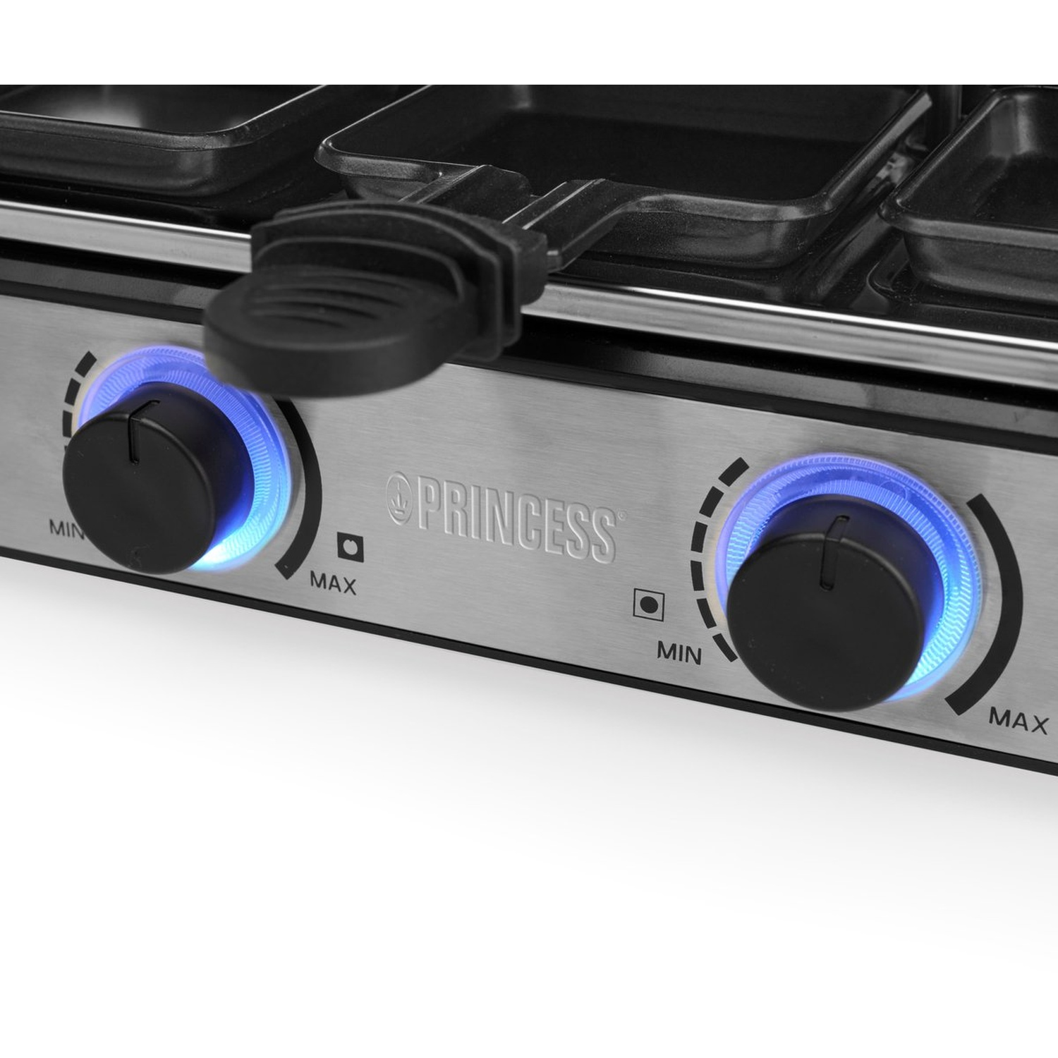 Close-up van een raclette grill met twee draaiknoppen en blauwe verlichting.
