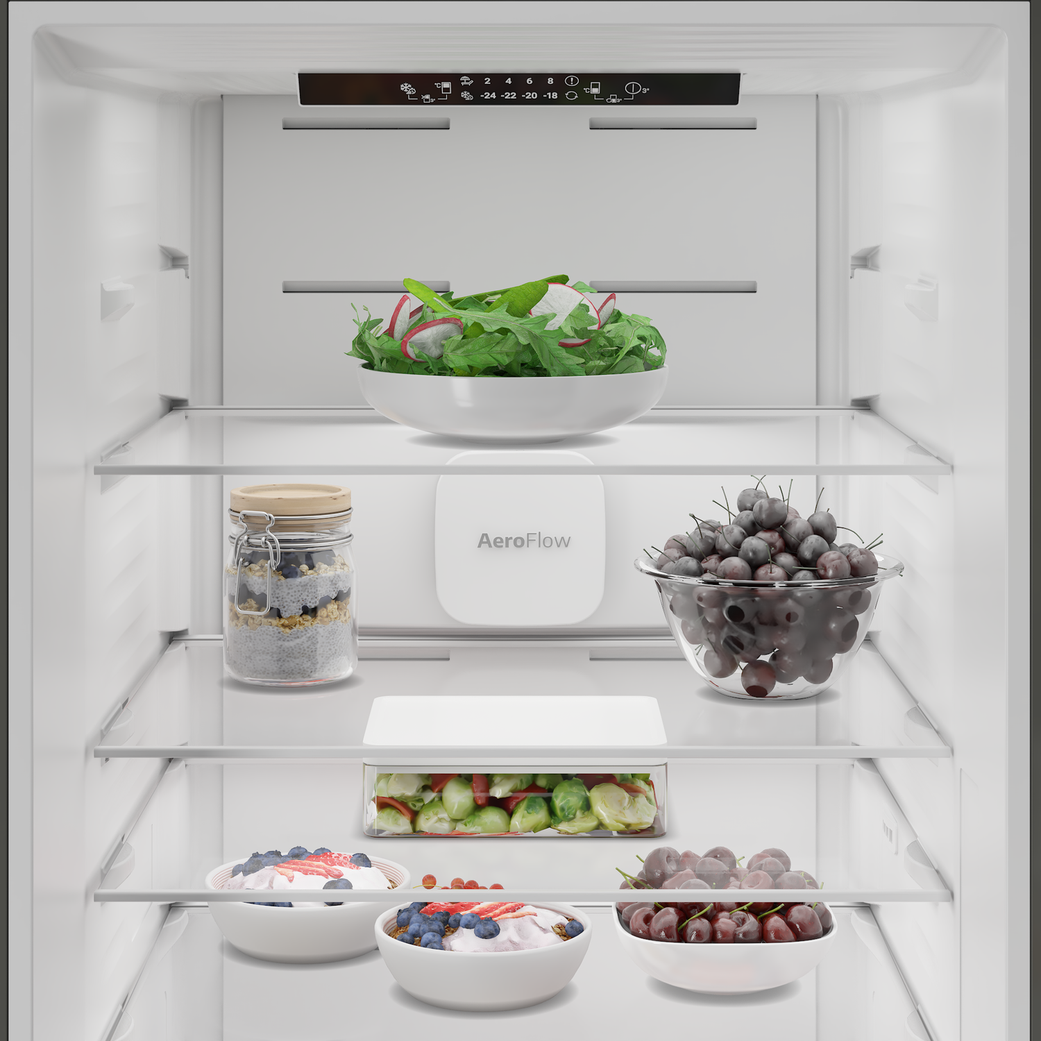 Refrigerator stocked with fruits, salad, and yogurt. Blueberries, cherries, strawberries.