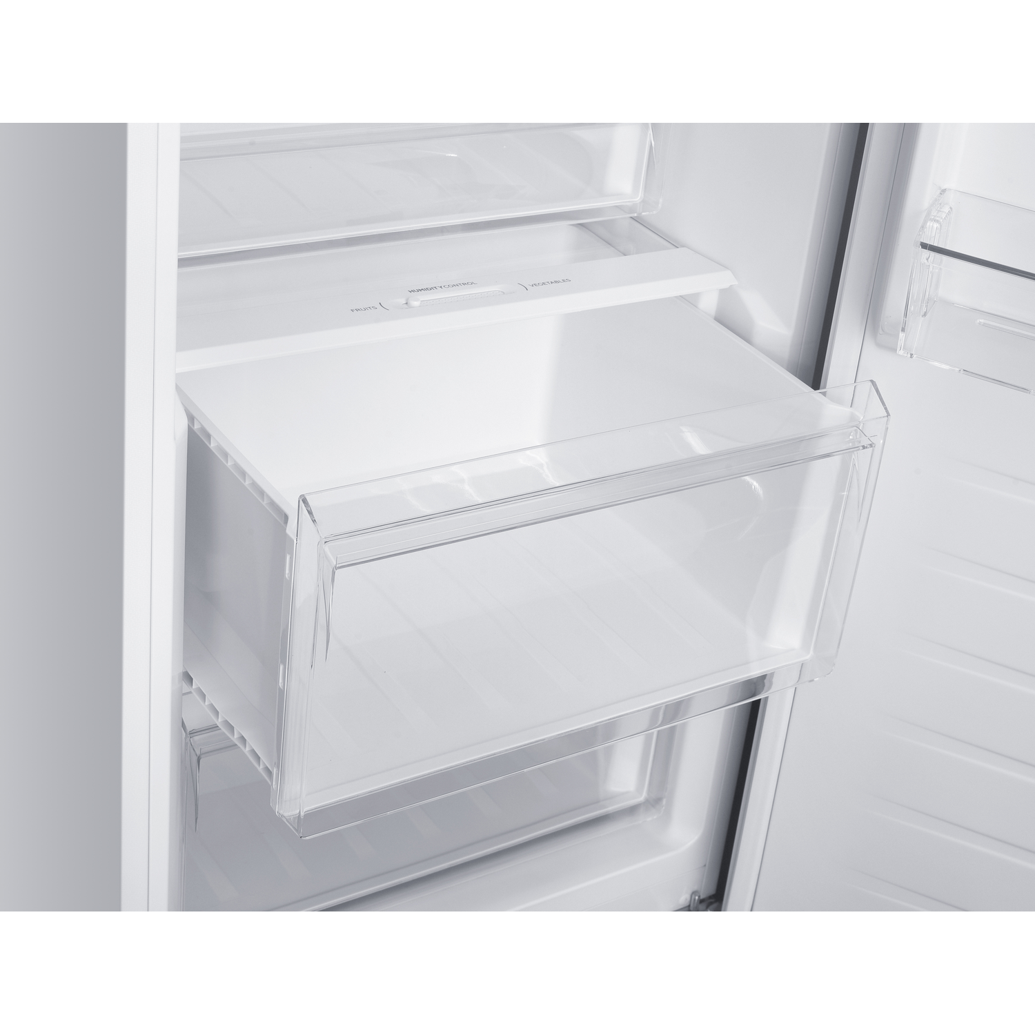 Interior view of an empty refrigerator with a crisper drawer for fruits and vegetables.