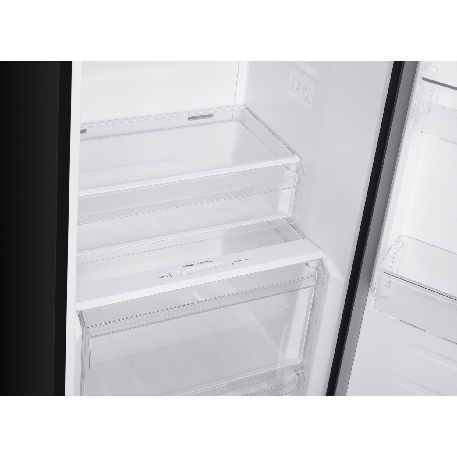 Empty white refrigerator shelves with clear drawers and humidity control.