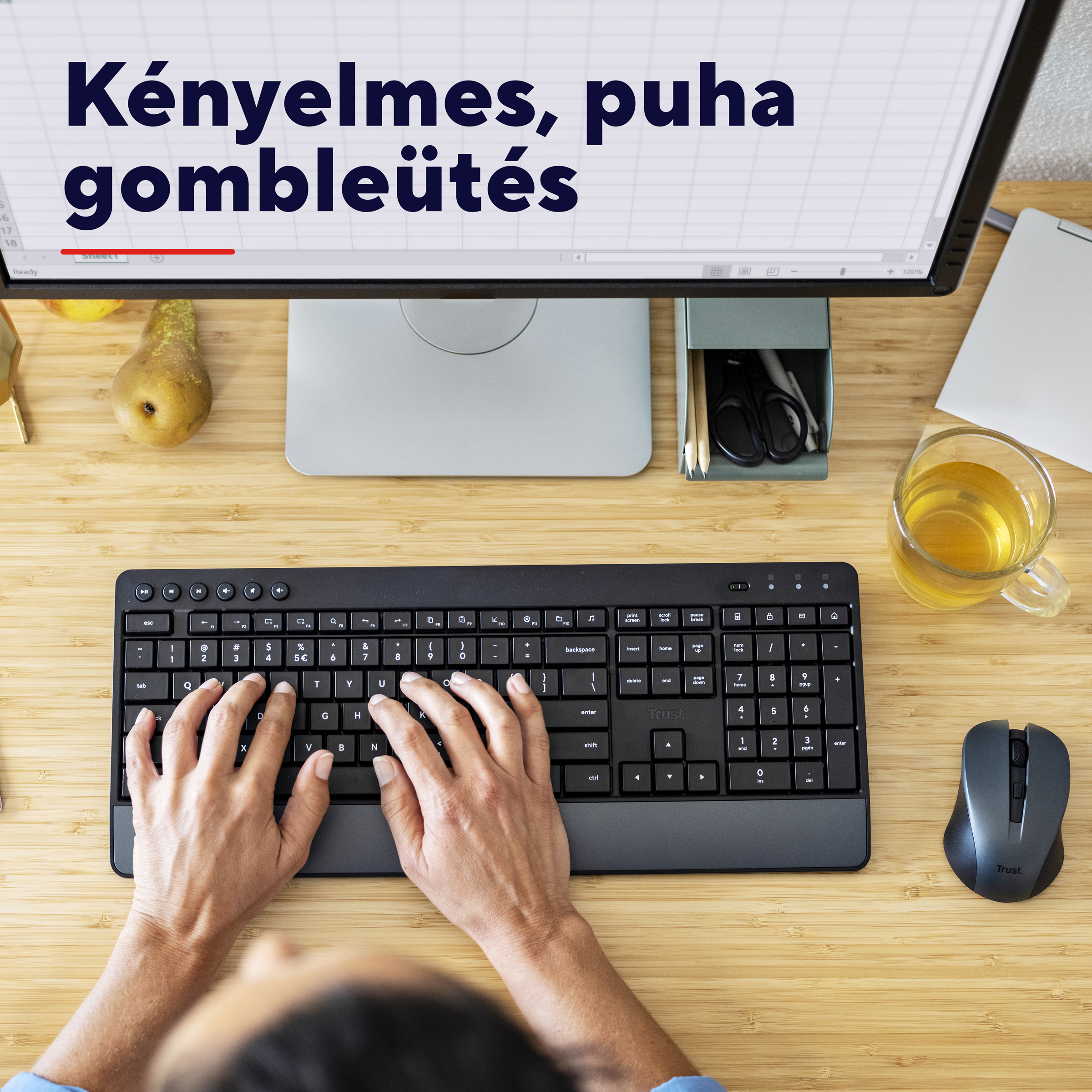 Egy személy egy számítógép monitor előtt gépel.
