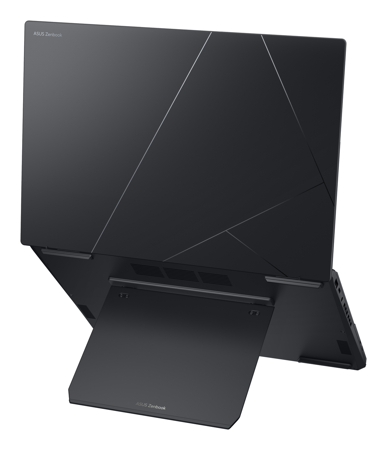 Un portátil ASUS Zenbook gris oscuro con diseño geométrico en la tapa está abierto.