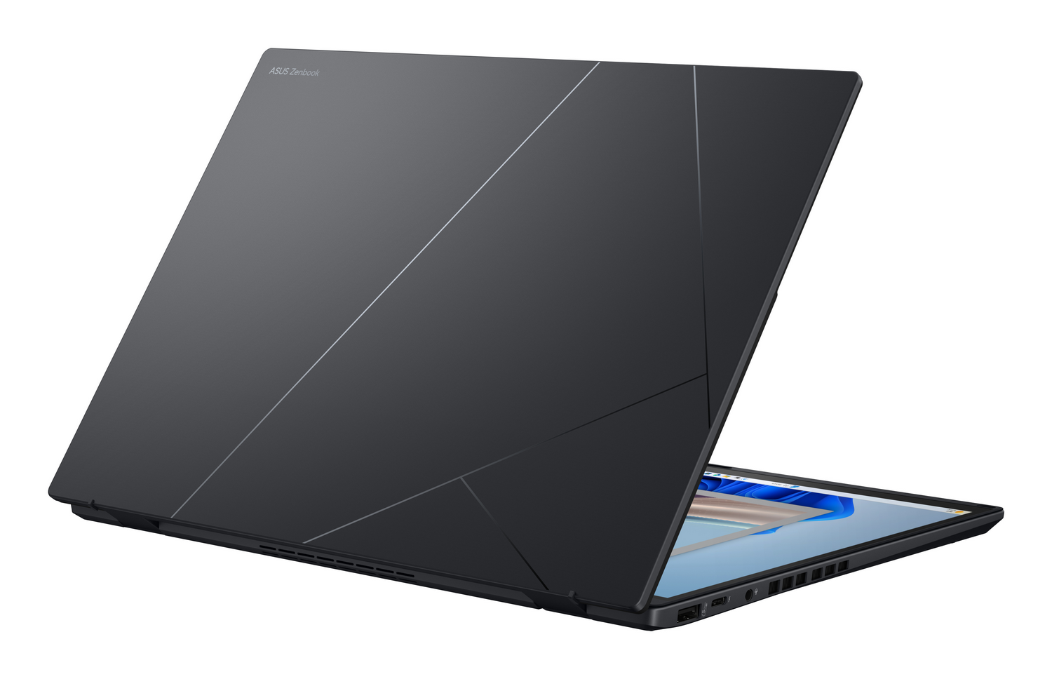 Un portátil ASUS Zenbook oscuro está abierto. La tapa es gris oscuro con patrones.