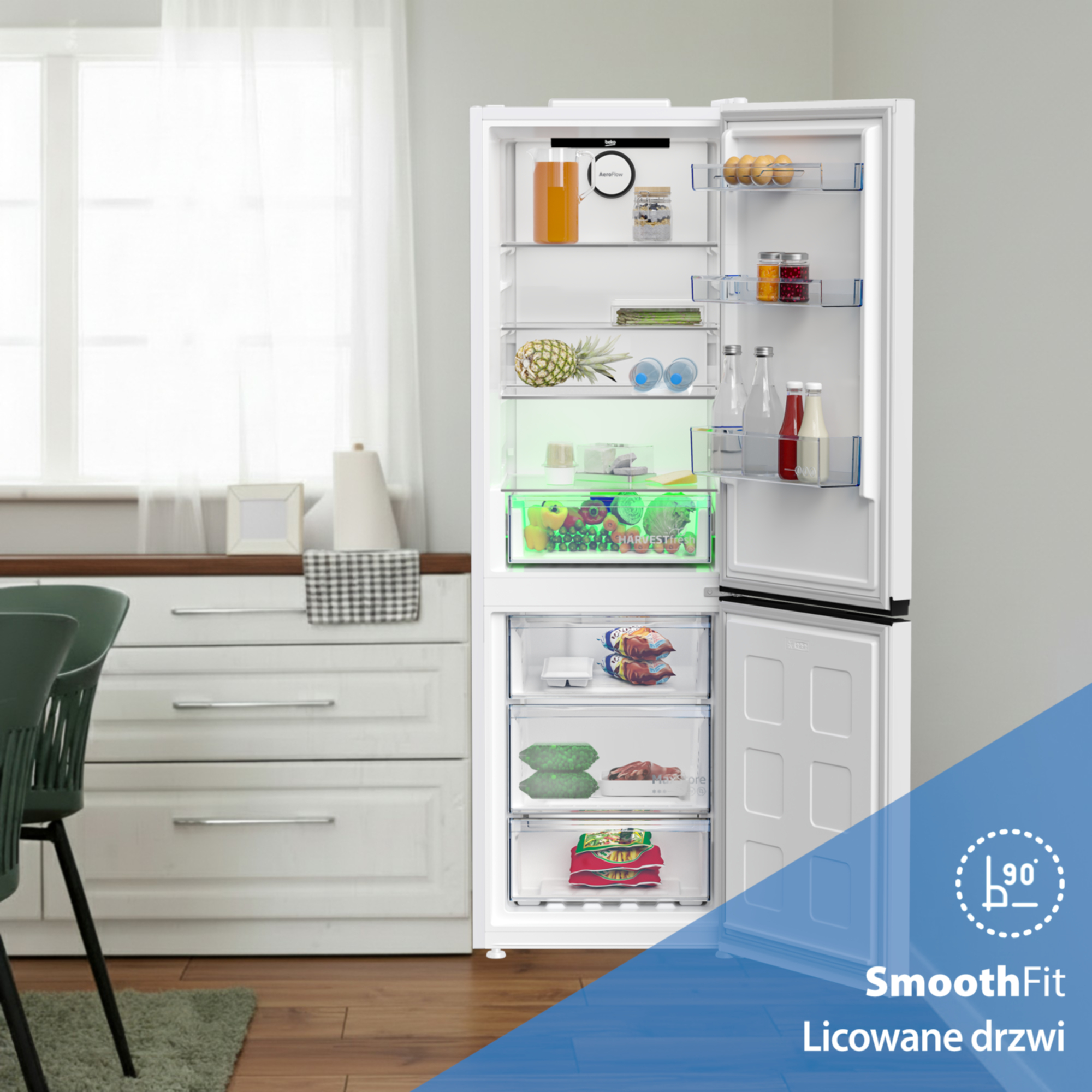 Otwarta biała lodówka z jedzeniem i szufladami.