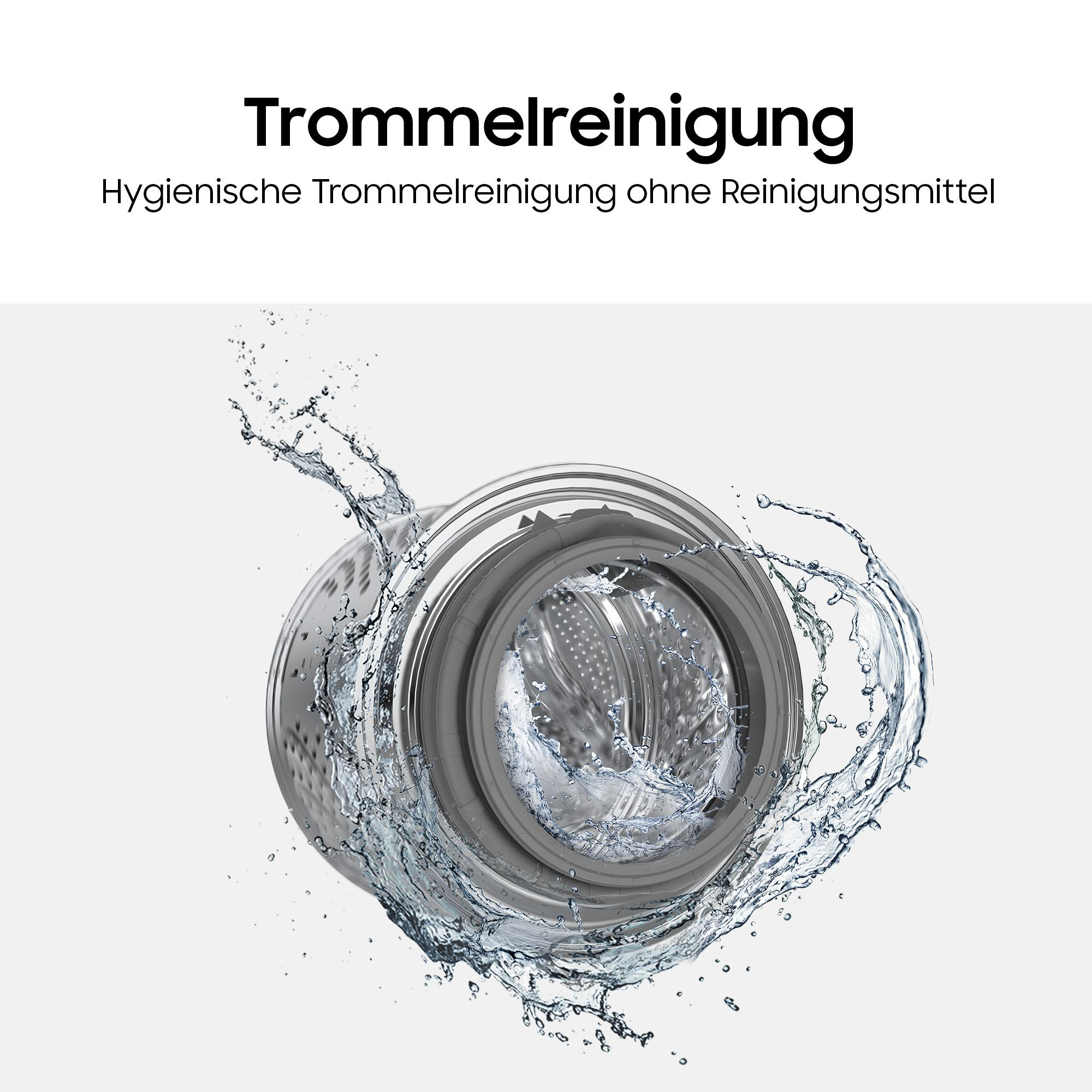 Wassertropfen spritzen auf die Trommel einer Waschmaschine.