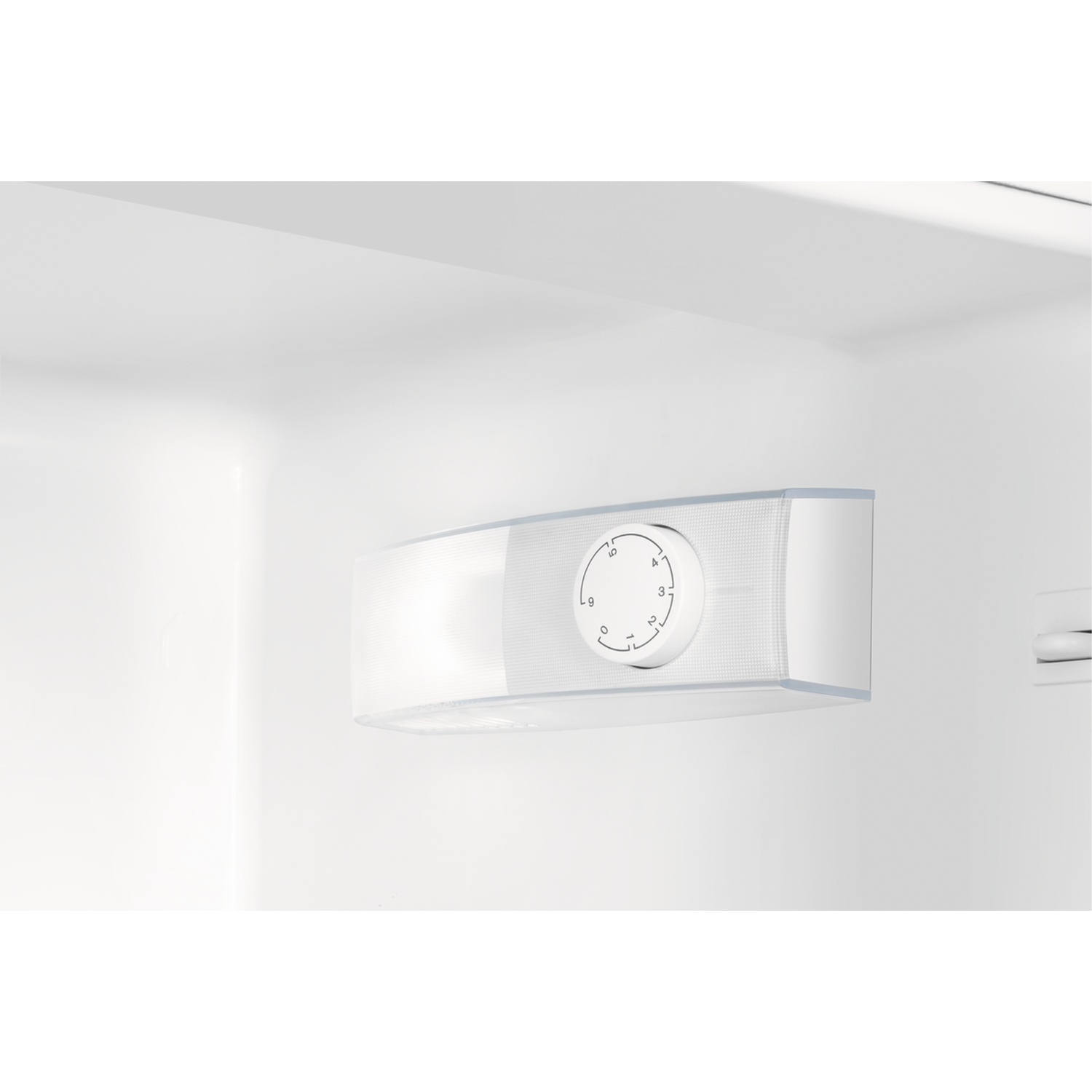 A white temperature dial with numbers 0 to 9 inside a refrigerator.