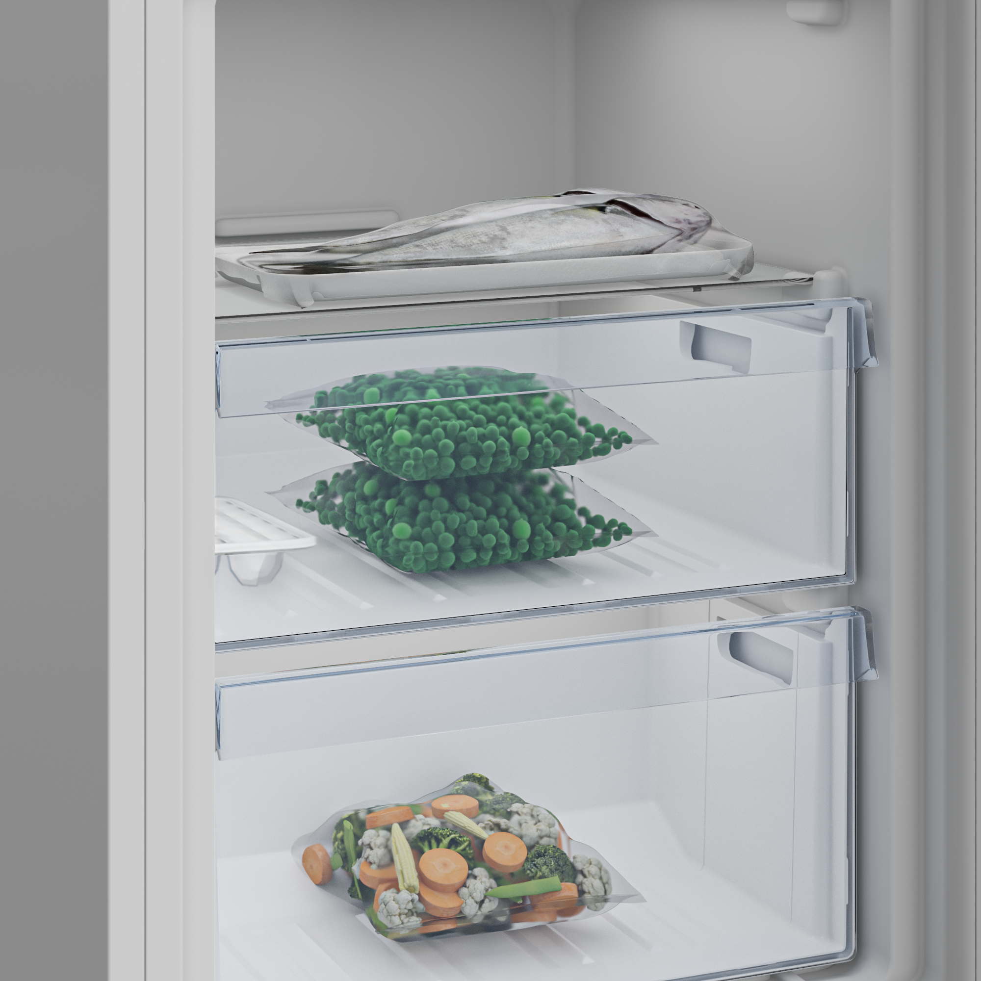 Ryba na tacy nad dwoma workami grochu i jednym workiem mieszanych warzyw w lodówce.