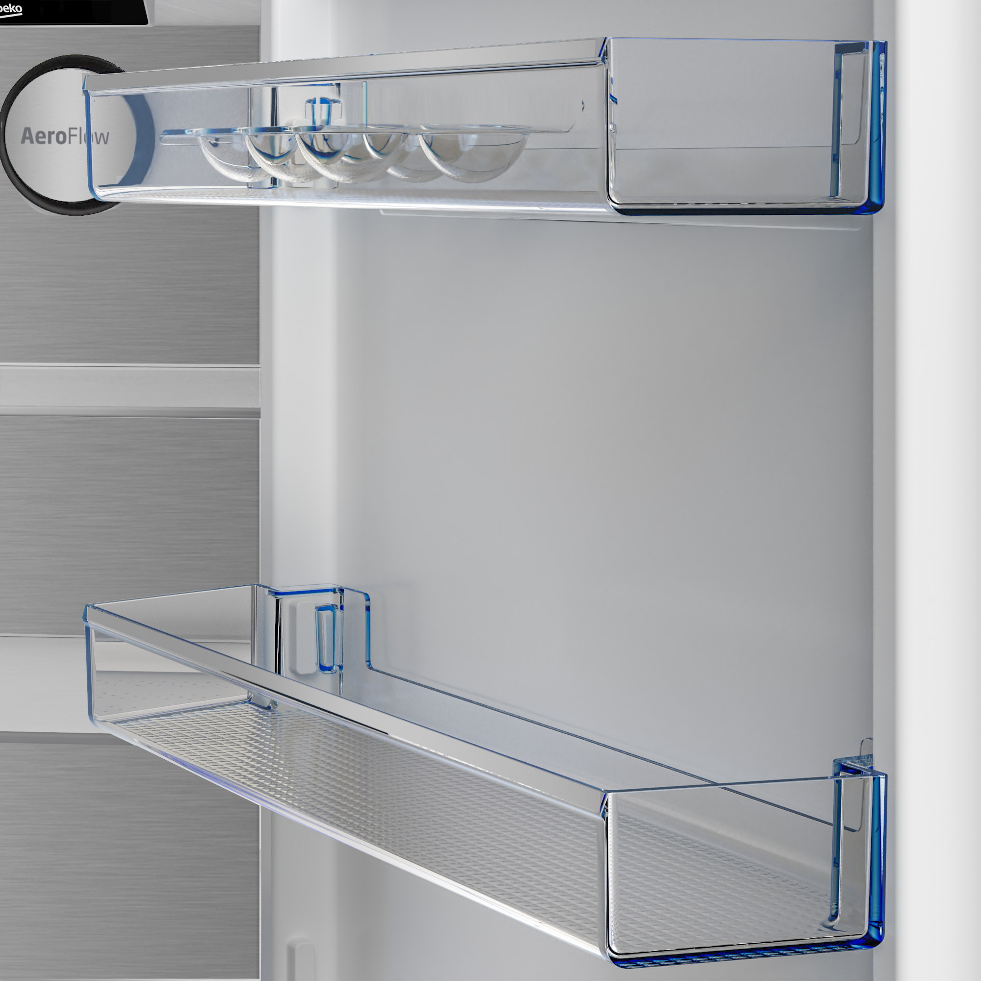 Półka w lodówce z pojemnikami na jajka i większą półką poniżej.