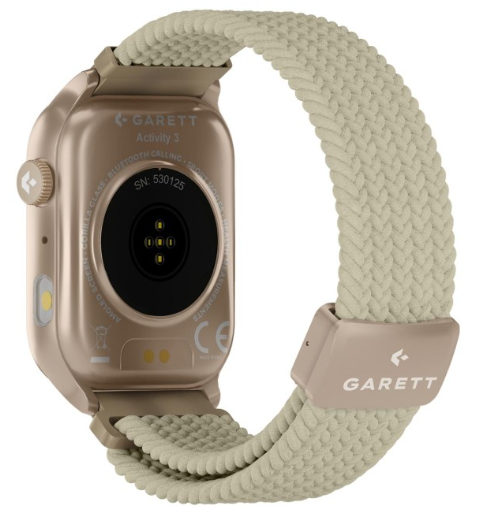 Złoty smartwatch z beżowym paskiem z tkaniny, tył pokazujący czujnik tętna i detale.