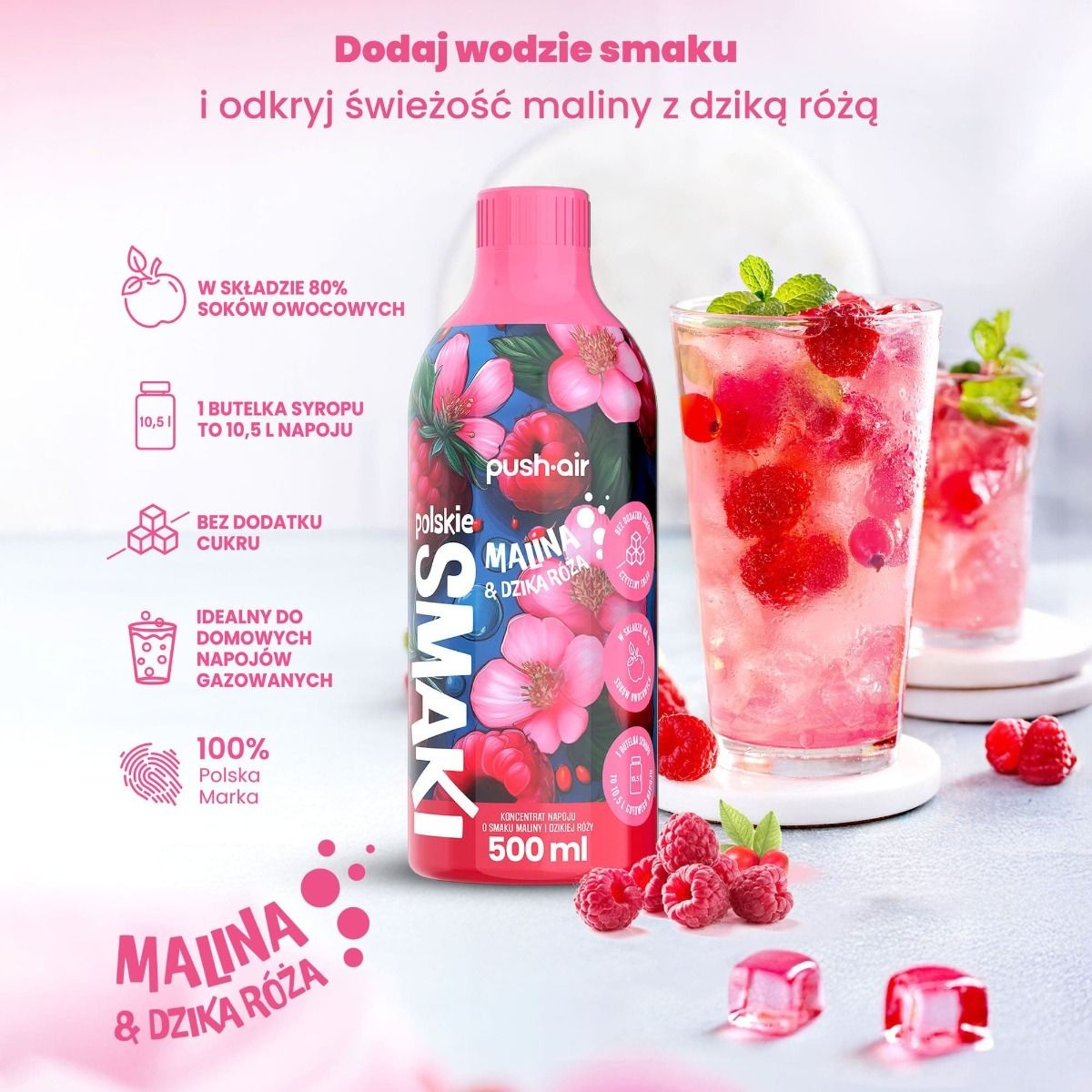 Butelka syropu malinowo-różanego obok szklanek z napojem i owocami.