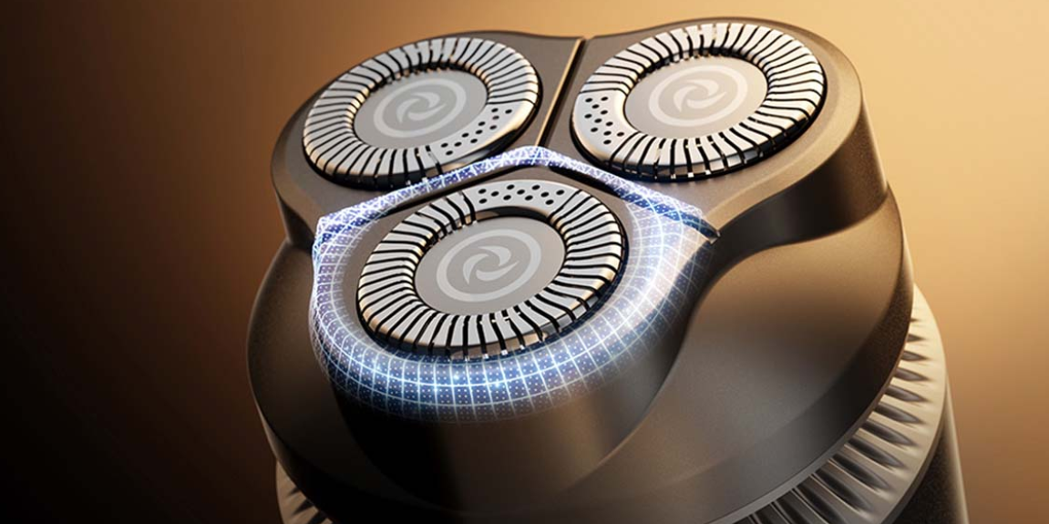 Zbliżenie głowicy golarki z trzema okrągłymi ostrzami i niebieskimi efektami świetlnymi.