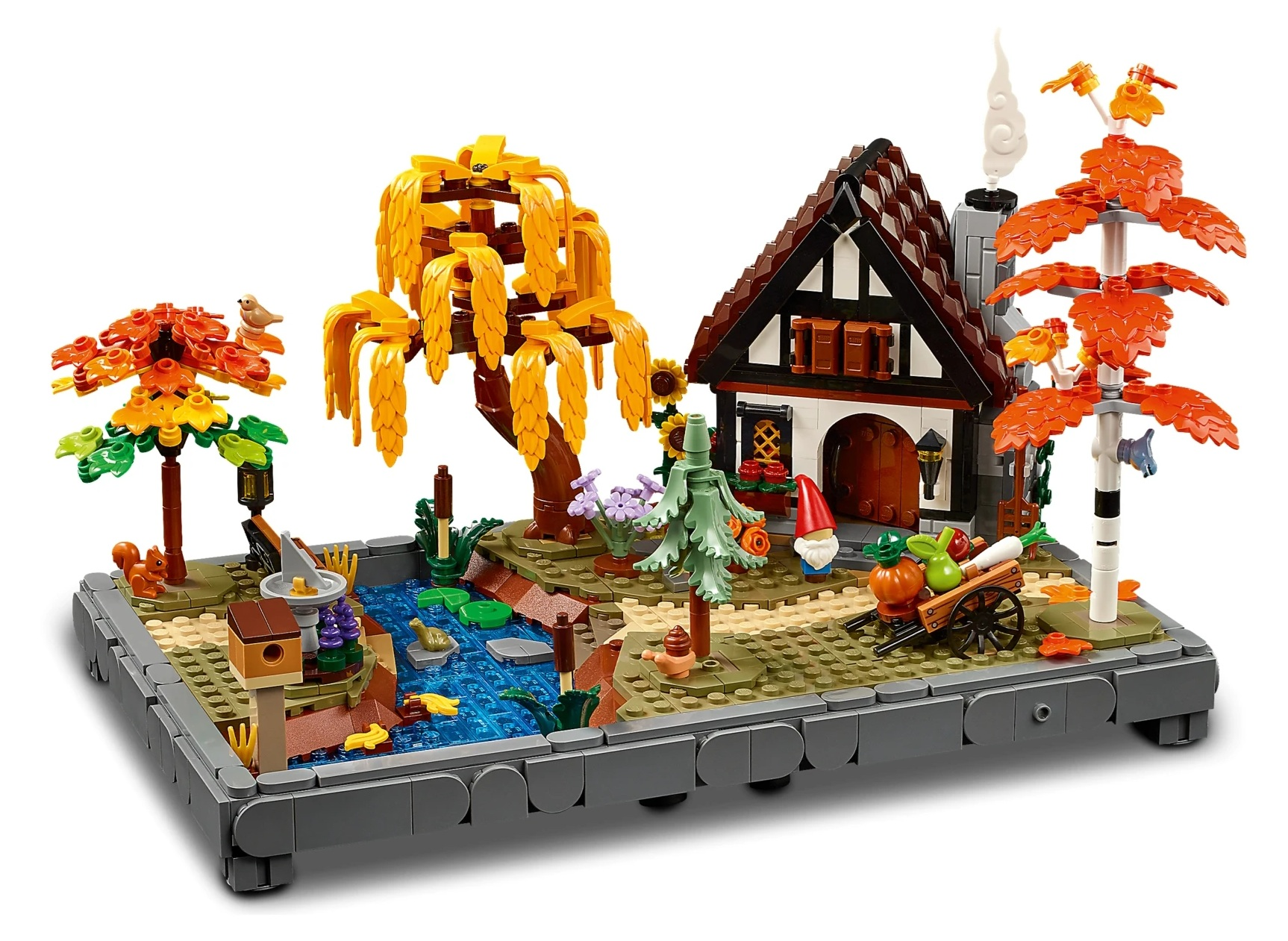 Ogród Lego z domem, stawem, drzewami, zwierzętami i wózkiem na plony.