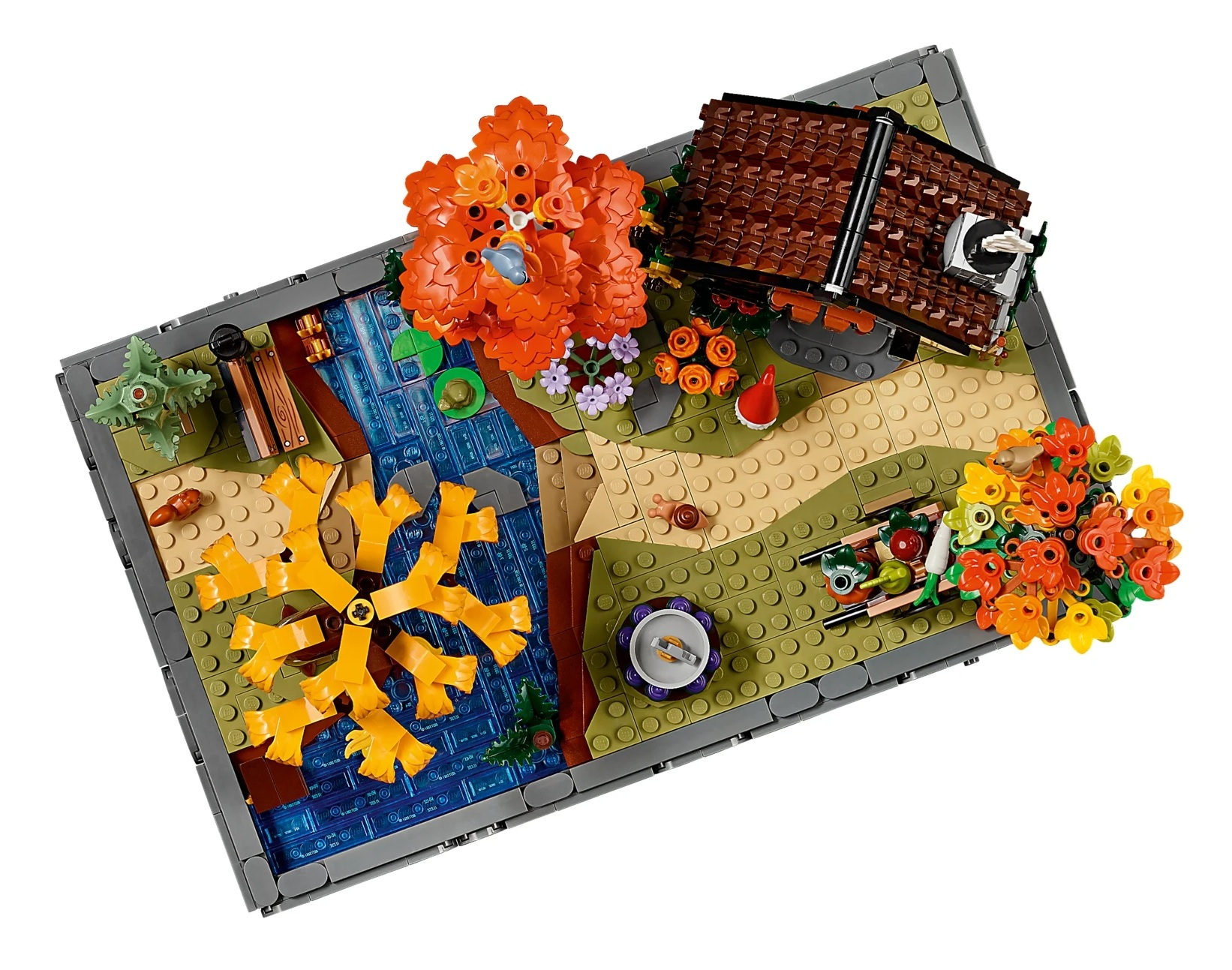 Scena jesienna Lego z domem, rzeką, żółtym drzewem i kwiatami.