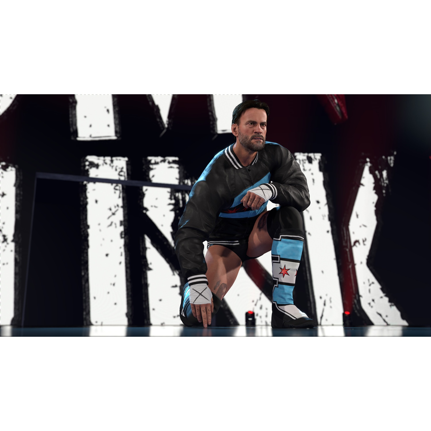A wrestler in black and blue attire crouches on a stage with a large graphic backdrop.