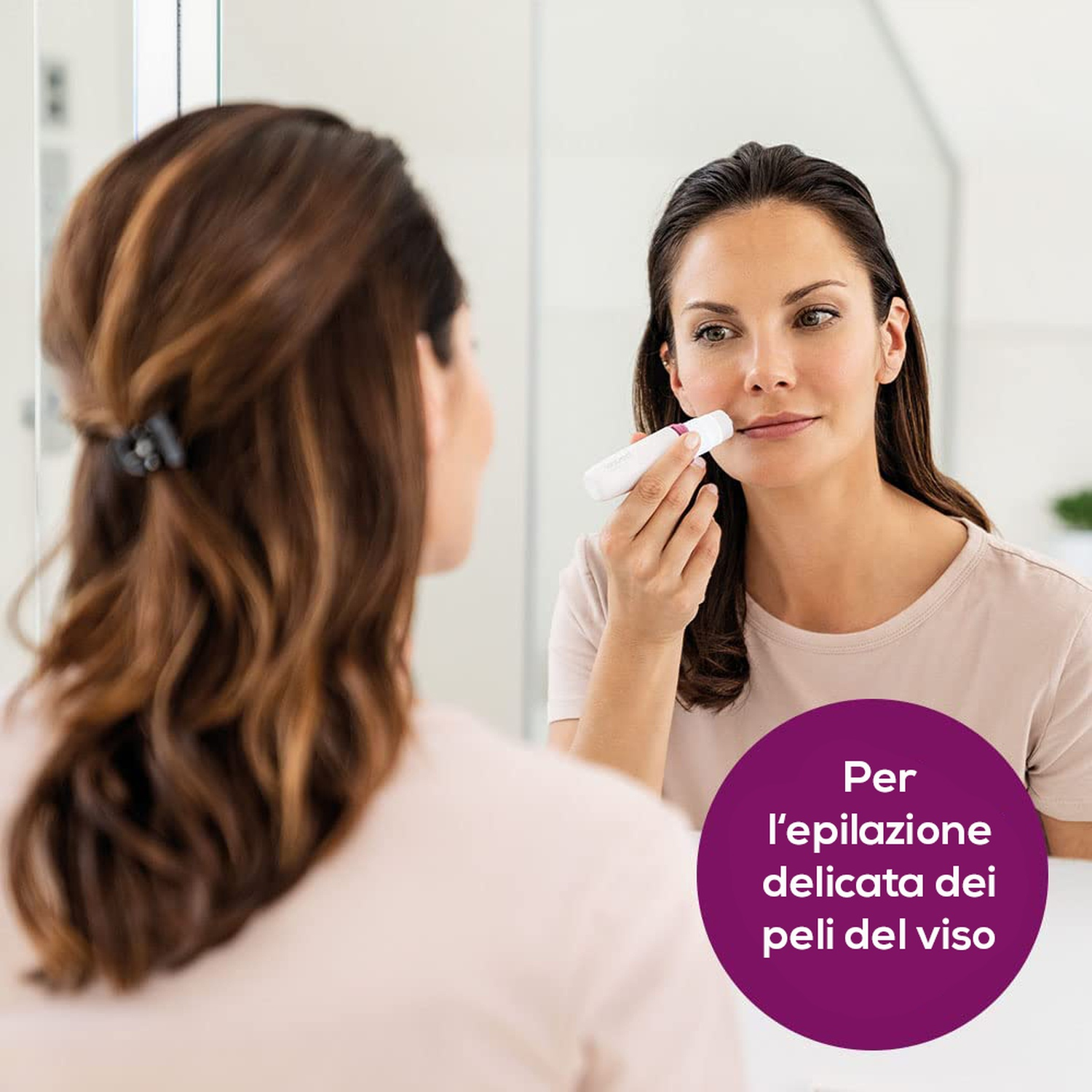 Una donna usa un epilatore viso davanti a uno specchio. Cerchio viola con testo.