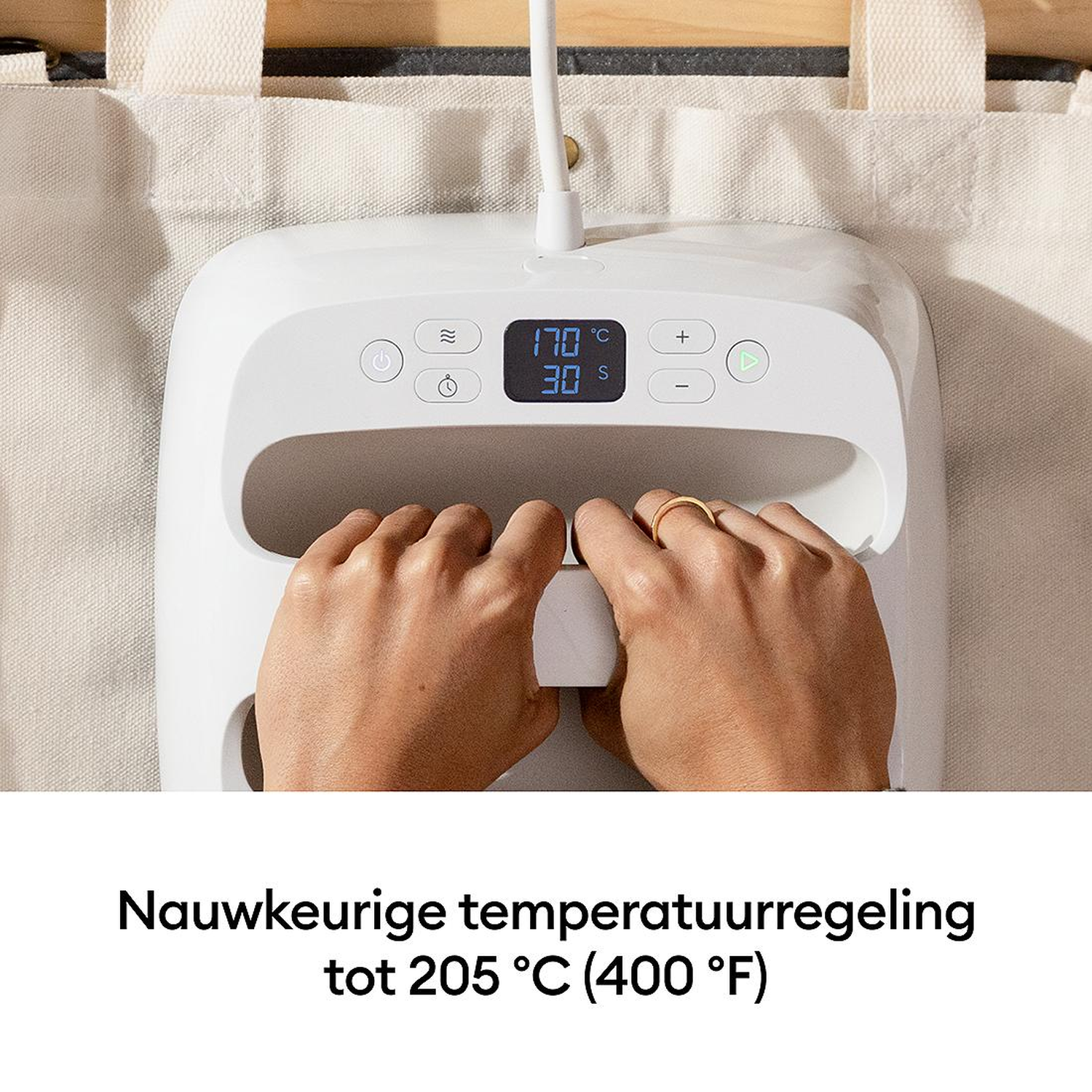 White heat press with hands holding handles. Digital display shows 170°C.