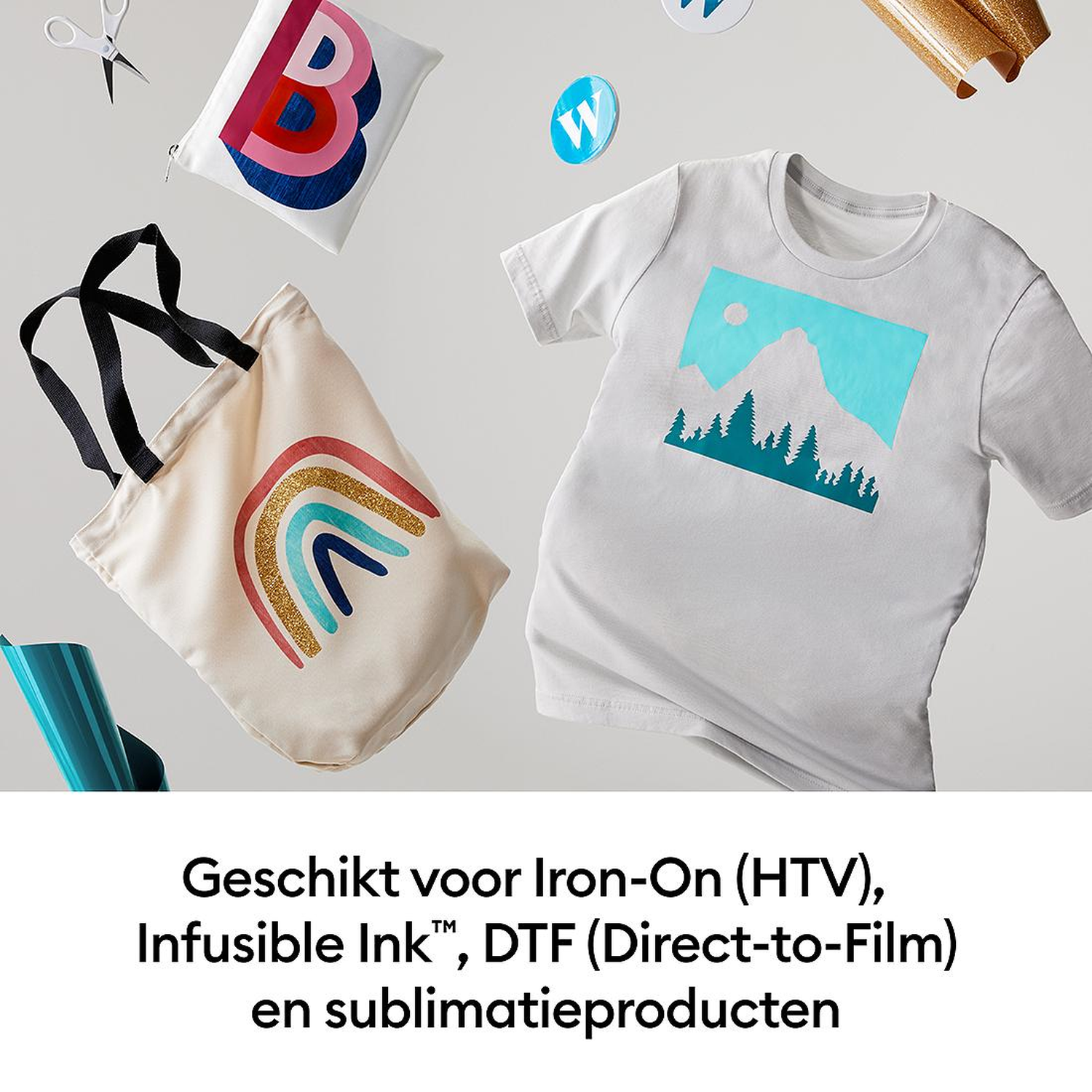 Tote bag with rainbow, T-shirt with mountain design, scissors, and film.