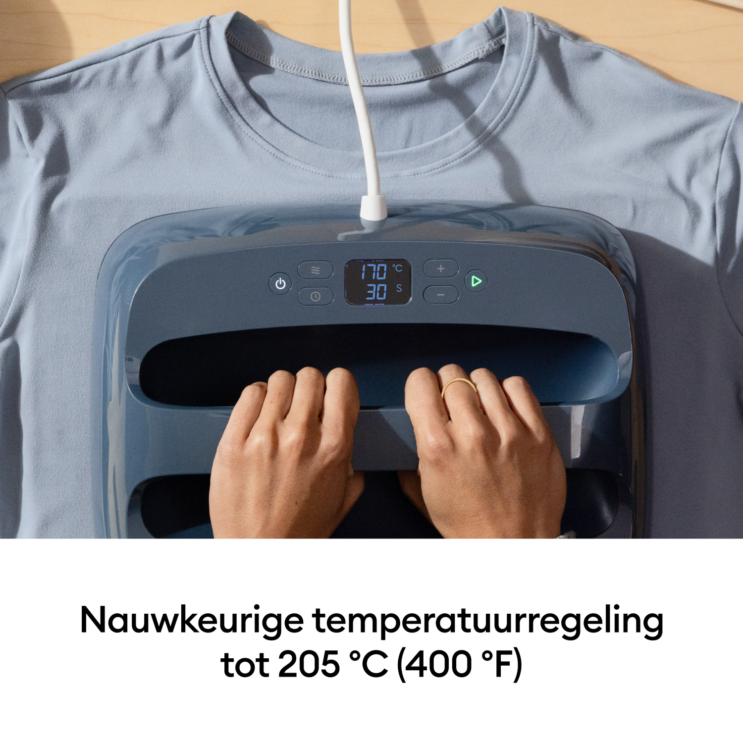 Blue t-shirt with heat press, hands on the press. Temp 170°C, Time 30s.