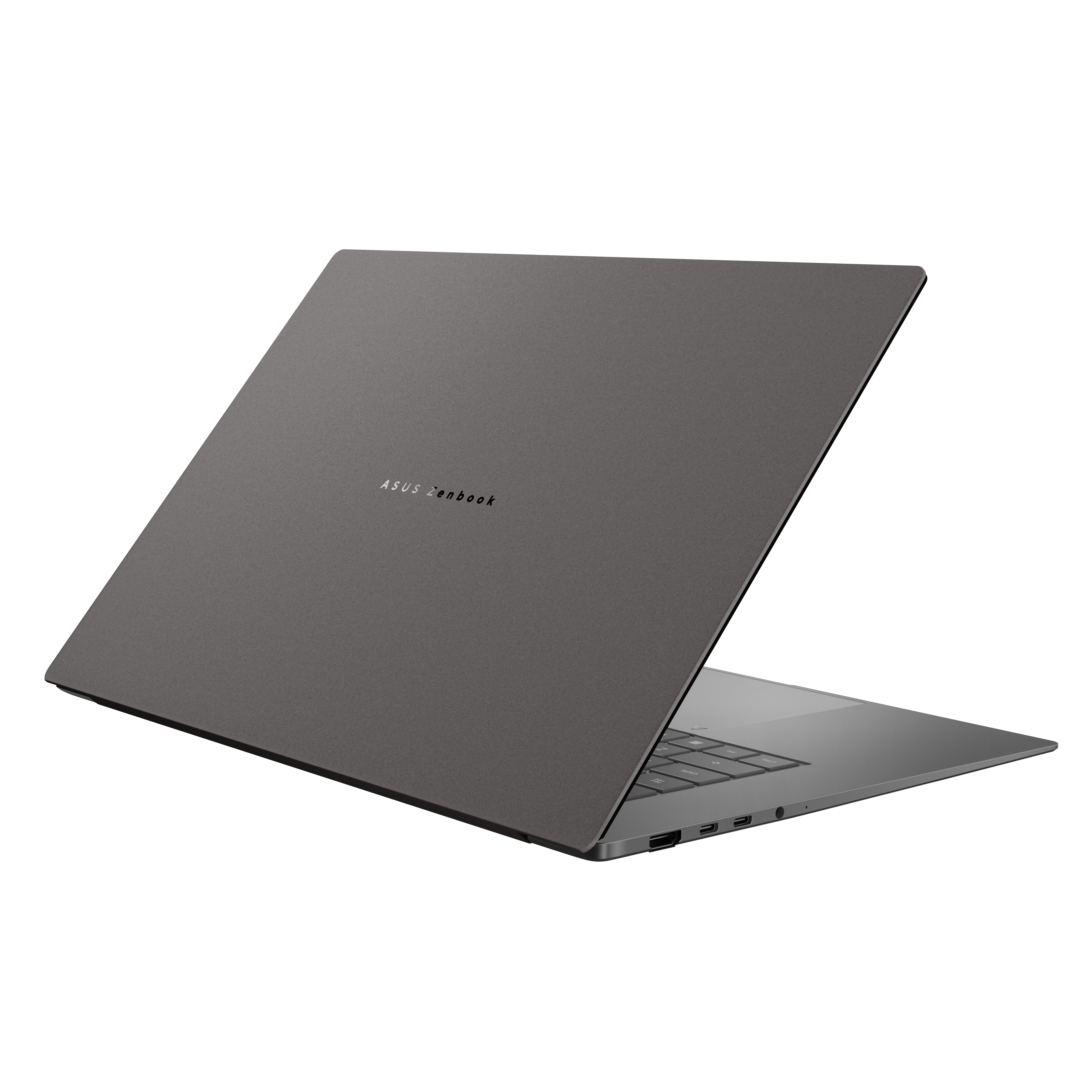 Ein geschlossener grauer ASUS Zenbook Laptop mit beleuchtetem Logo auf schwarzem Hintergrund.