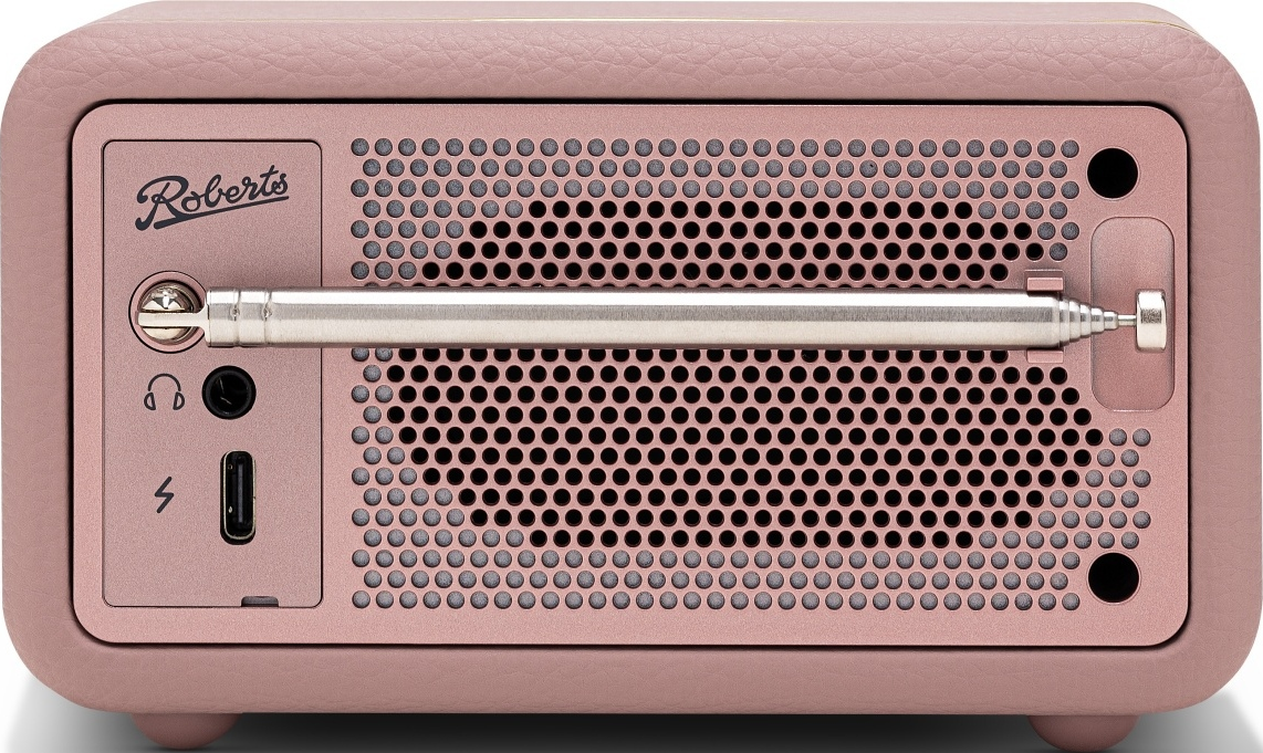 Une radio Roberts rose avec antenne extensible et grille de haut-parleur.