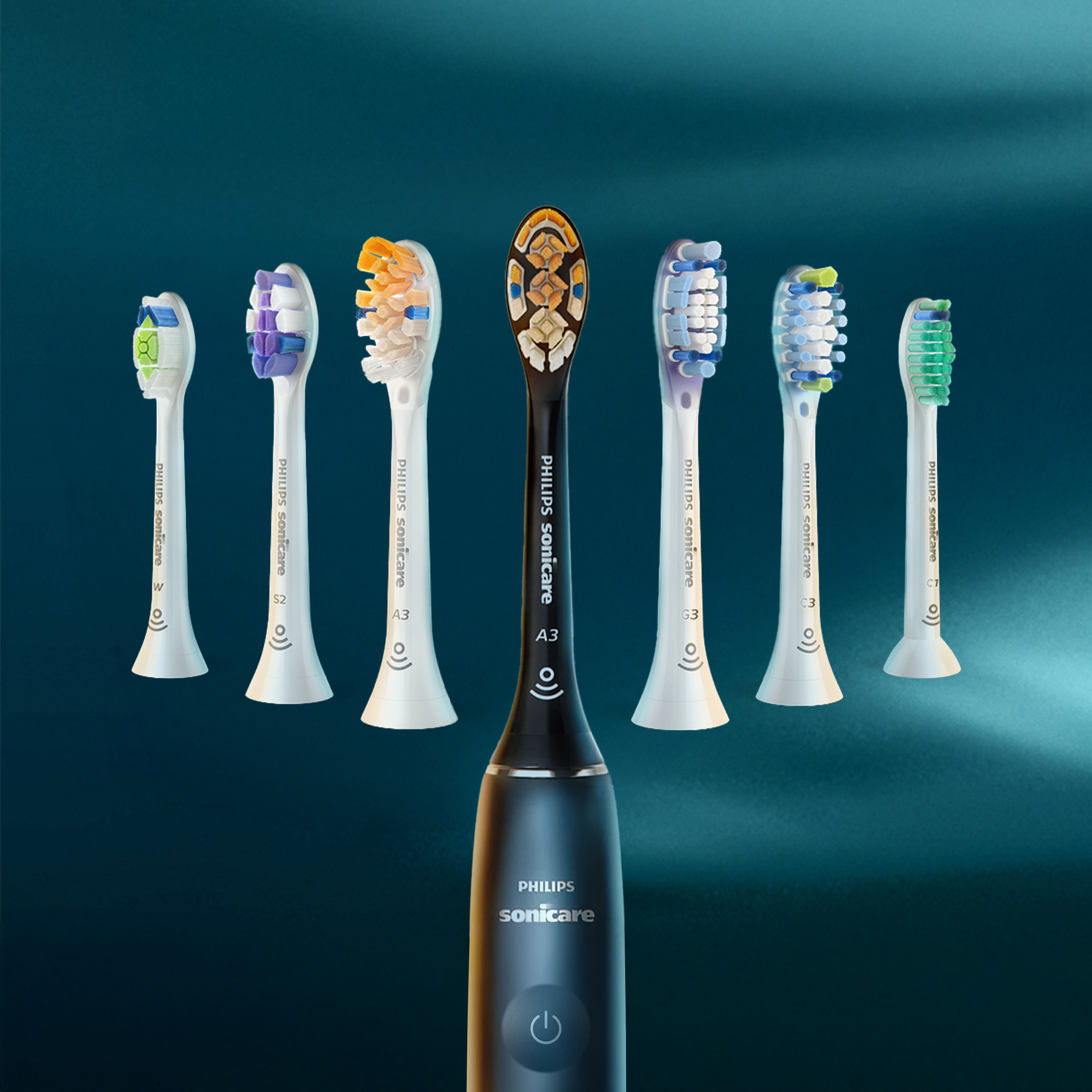 Czarna rączka szczoteczki Philips Sonicare z różnymi końcówkami w tle.