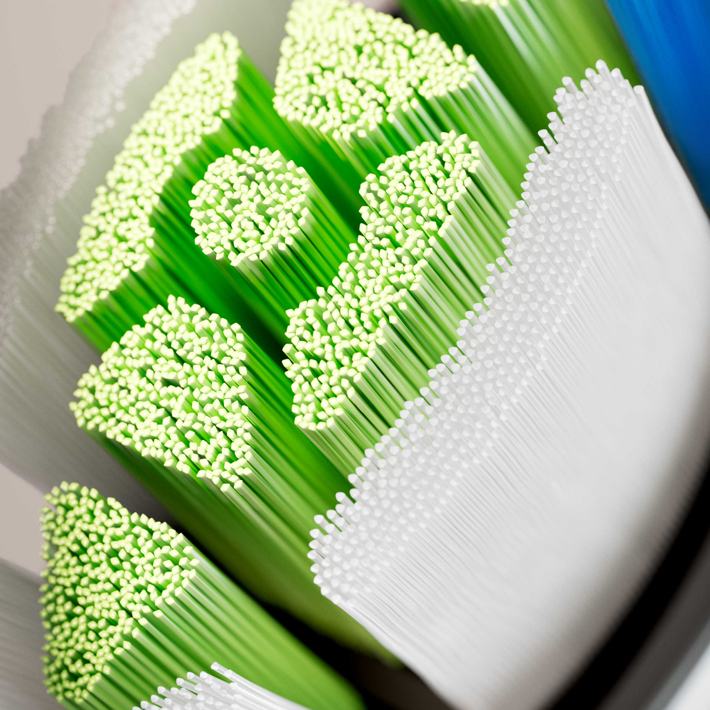 Zbliżenie na zielone i białe włosie szczoteczki do zębów.