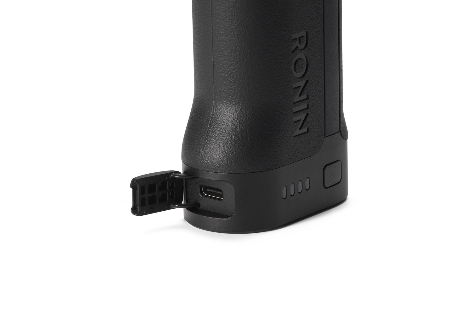 Primer plano de un dispositivo negro con puerto USB abierto y letras 'RONIN'.