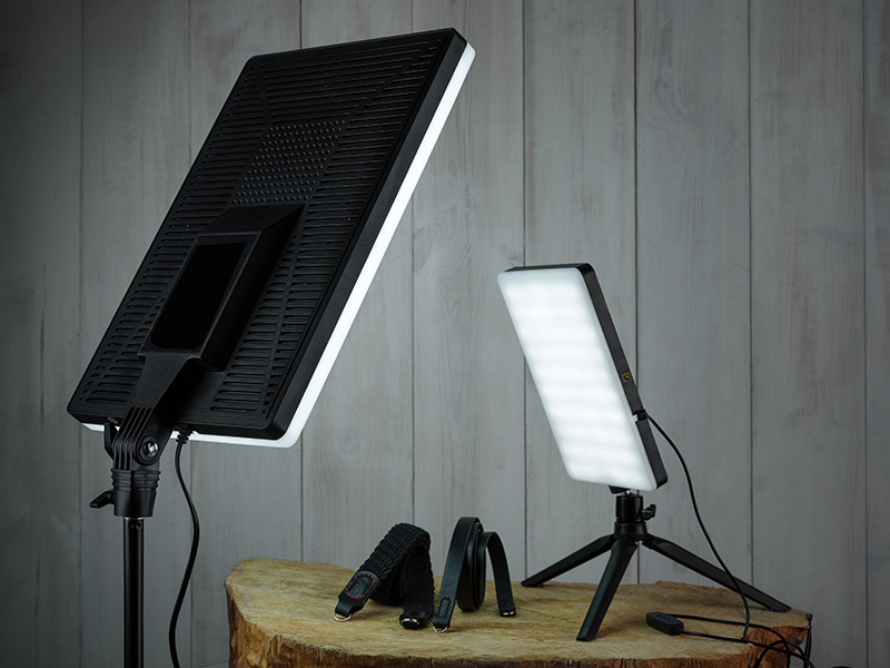 Dwa podświetlone panele LED na drewnianym tle, jeden duży, drugi mały.