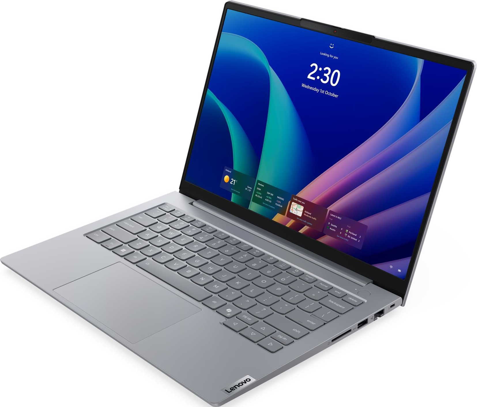 Ein graues Lenovo-Laptop mit beleuchtetem Bildschirm, der die Windows-Anmeldeseite zeigt.