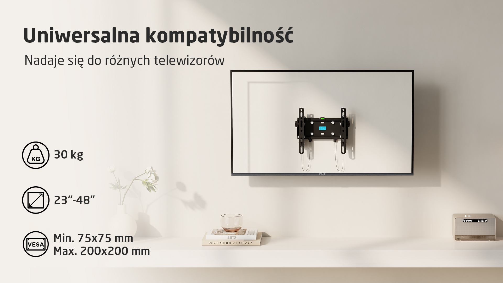 Czarny uchwyt ścienny do telewizora na białym telewizorze, udźwig 30 kg.